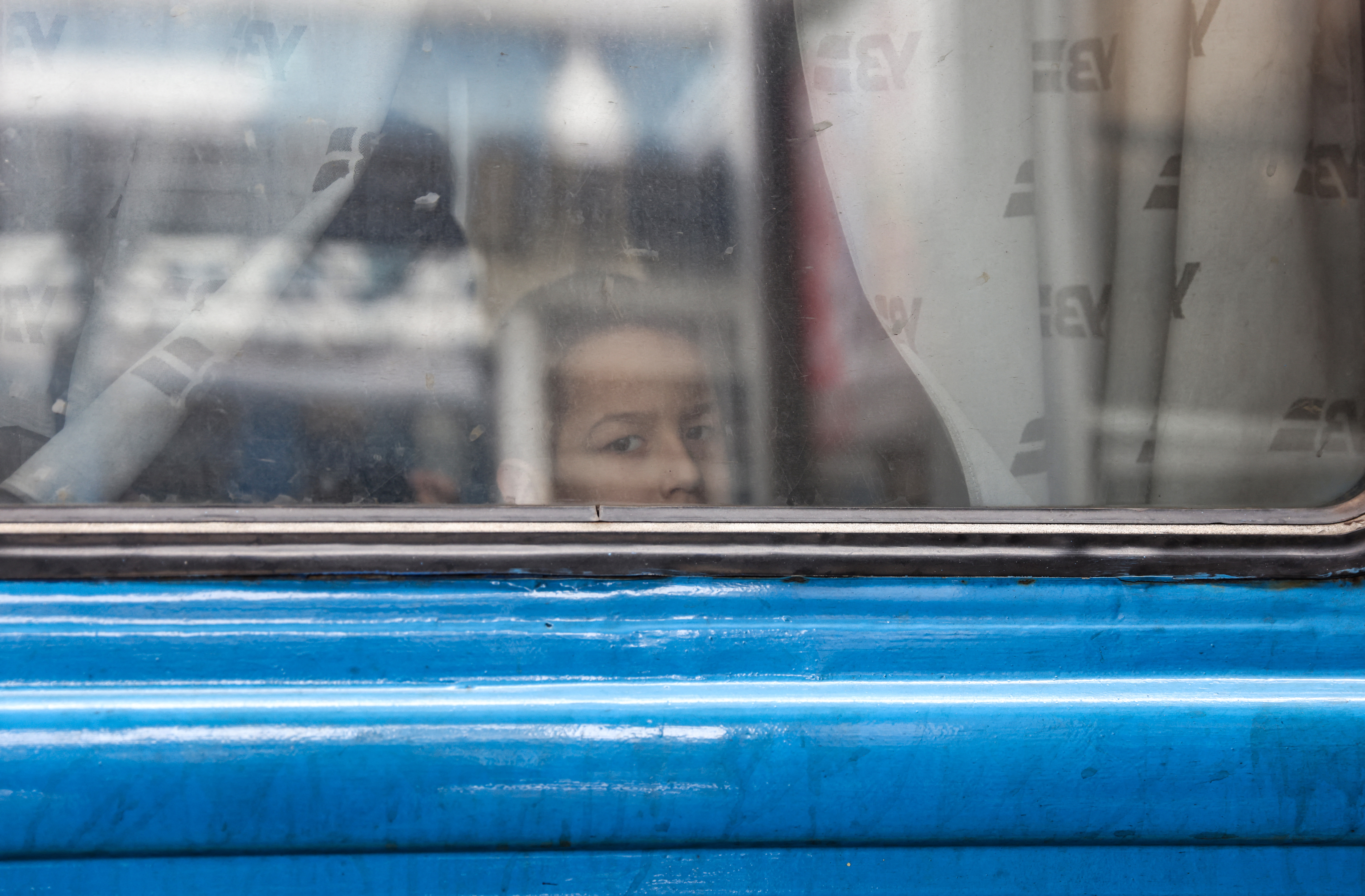 A boy looks out from an evacuation train at Kyiv central train station