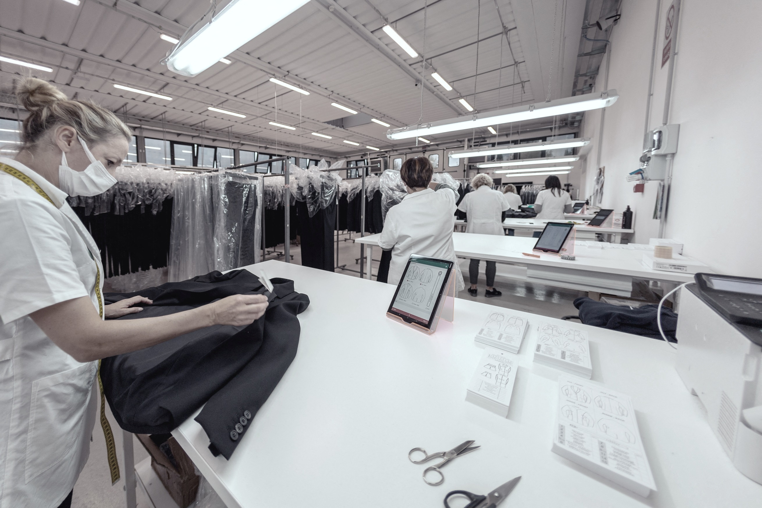 Giuntini employees work with designs of jackets for luxury brands, in Peccioli