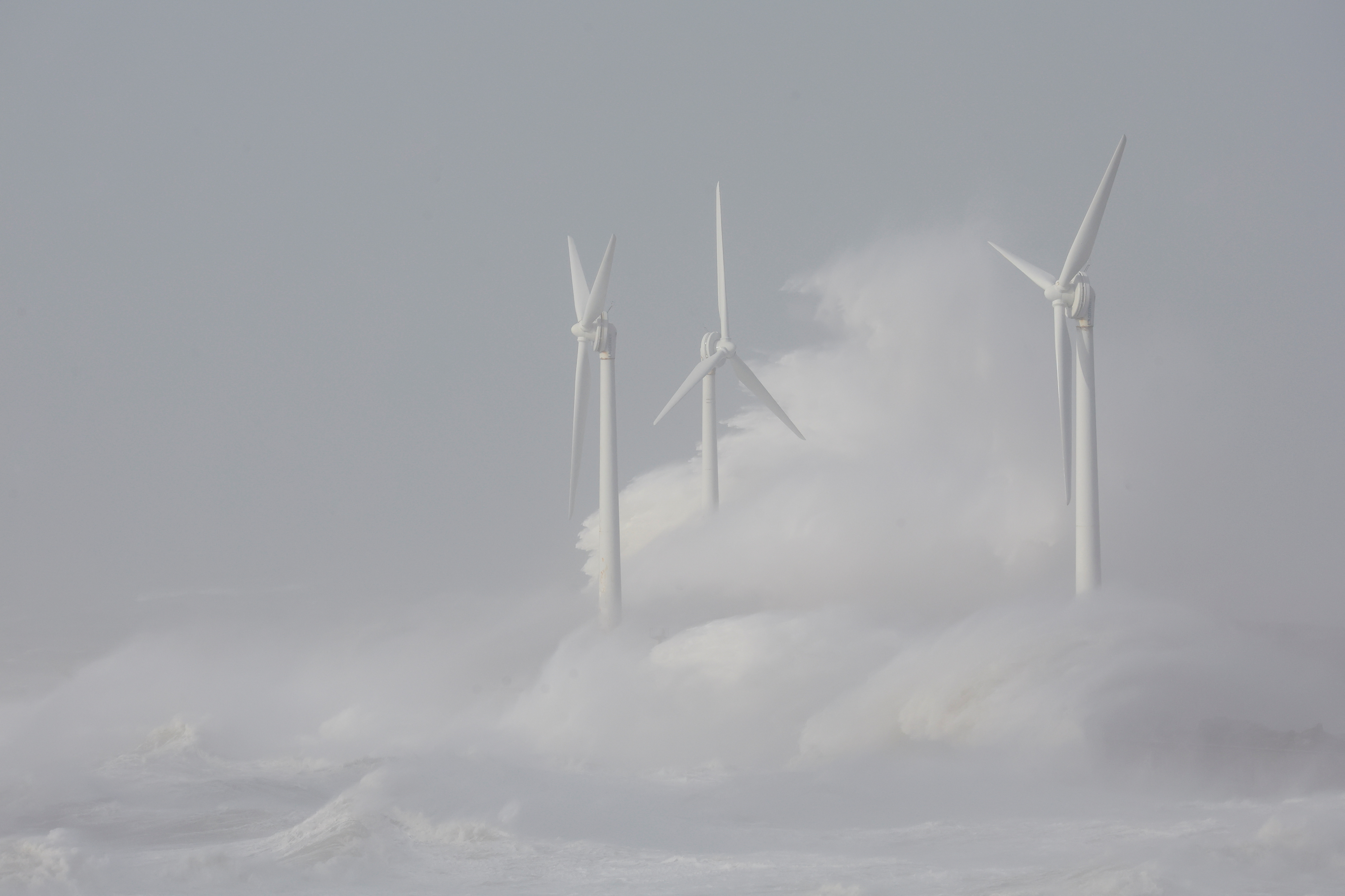 Waves crash against wind turbines during Storm Eunice at Boulogne-sur-Mer