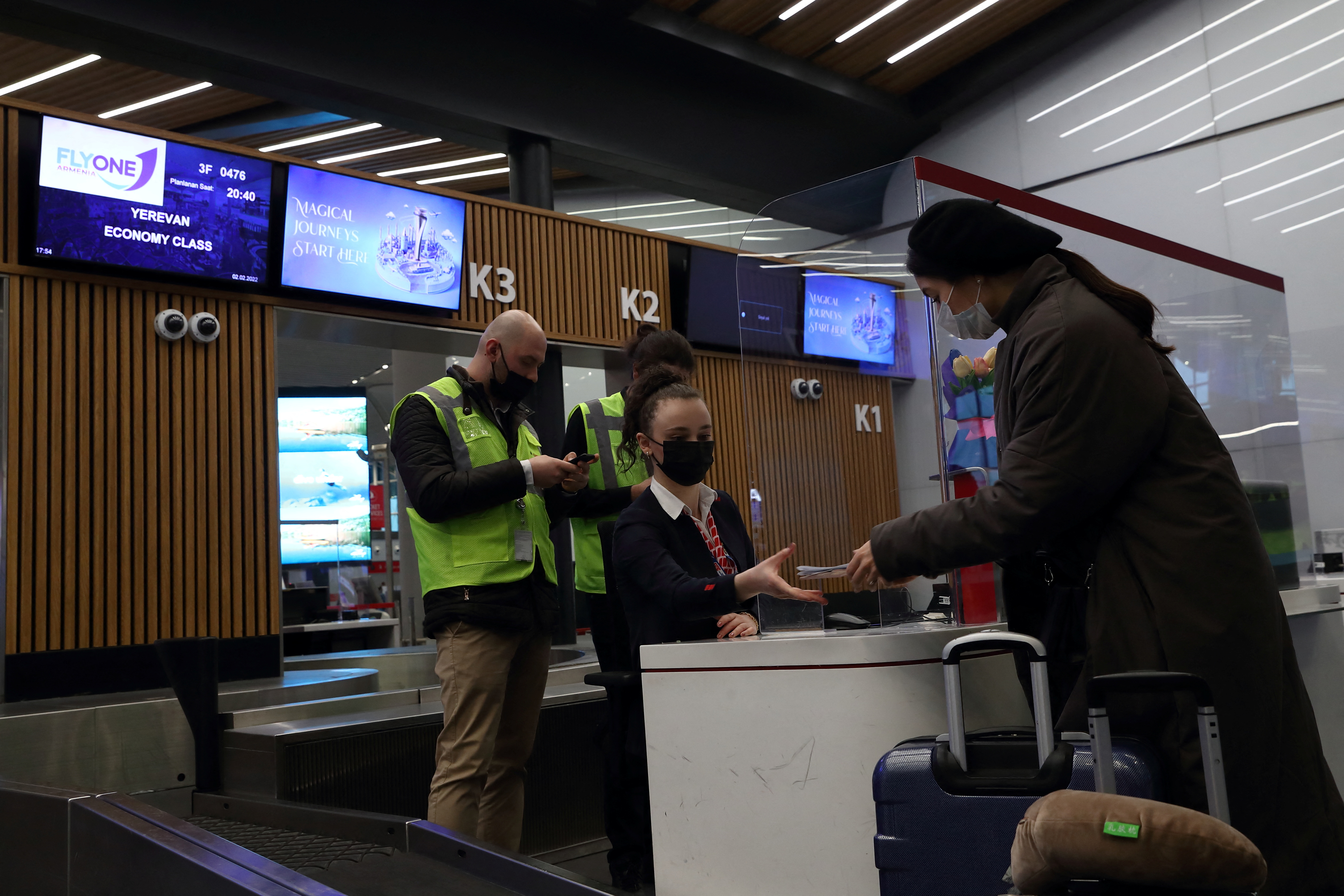 A passenger checks-in at the FlyOne Armenia counter for a flight from Istanbul to Yerevan at the Istanbul International Airport