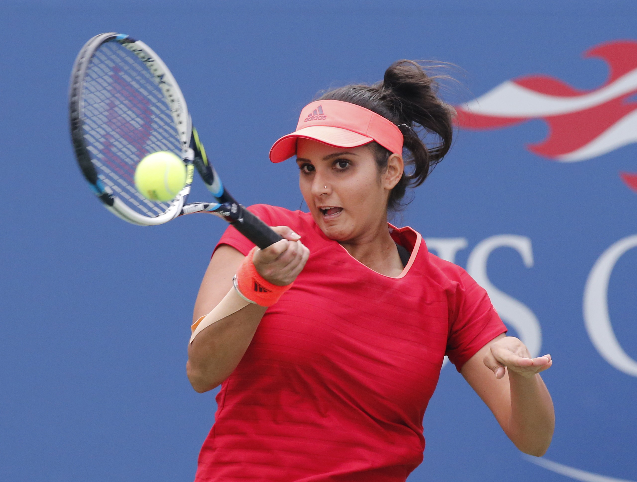 Mirza of India returns with playing partner Hingis of Switzerland as they face Dellacqua of Australia and Shvedova of Kazakhstan in the women's doubles final match at the U.S. Open Championships tennis tournament in New York