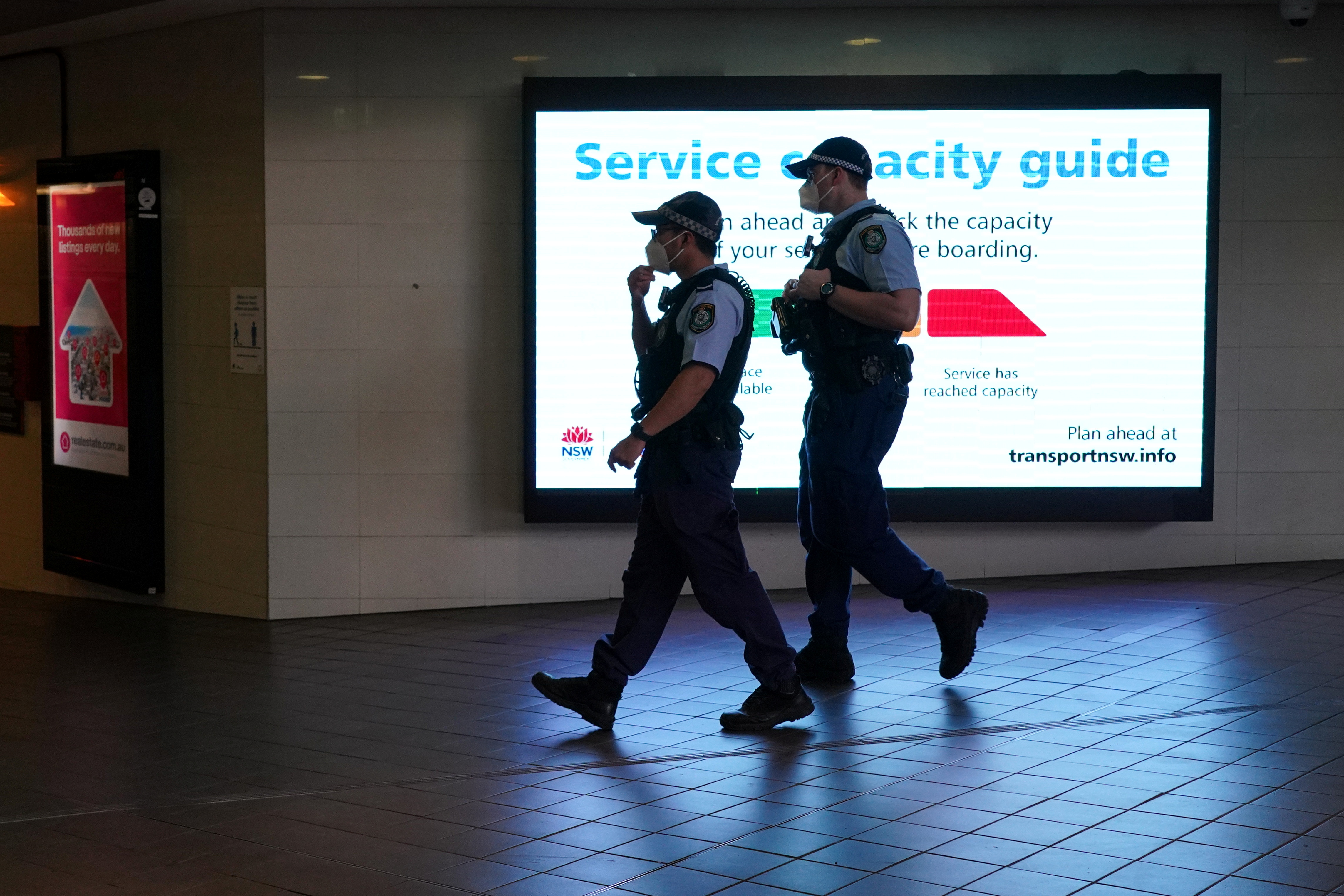 Police officers in protective face masks patrol a public transit station in the city centre during a lockdown to curb the spread of a coronavirus disease (COVID-19) in Sydney, Australia, September 30, 2021. REUTERS/Loren Elliott