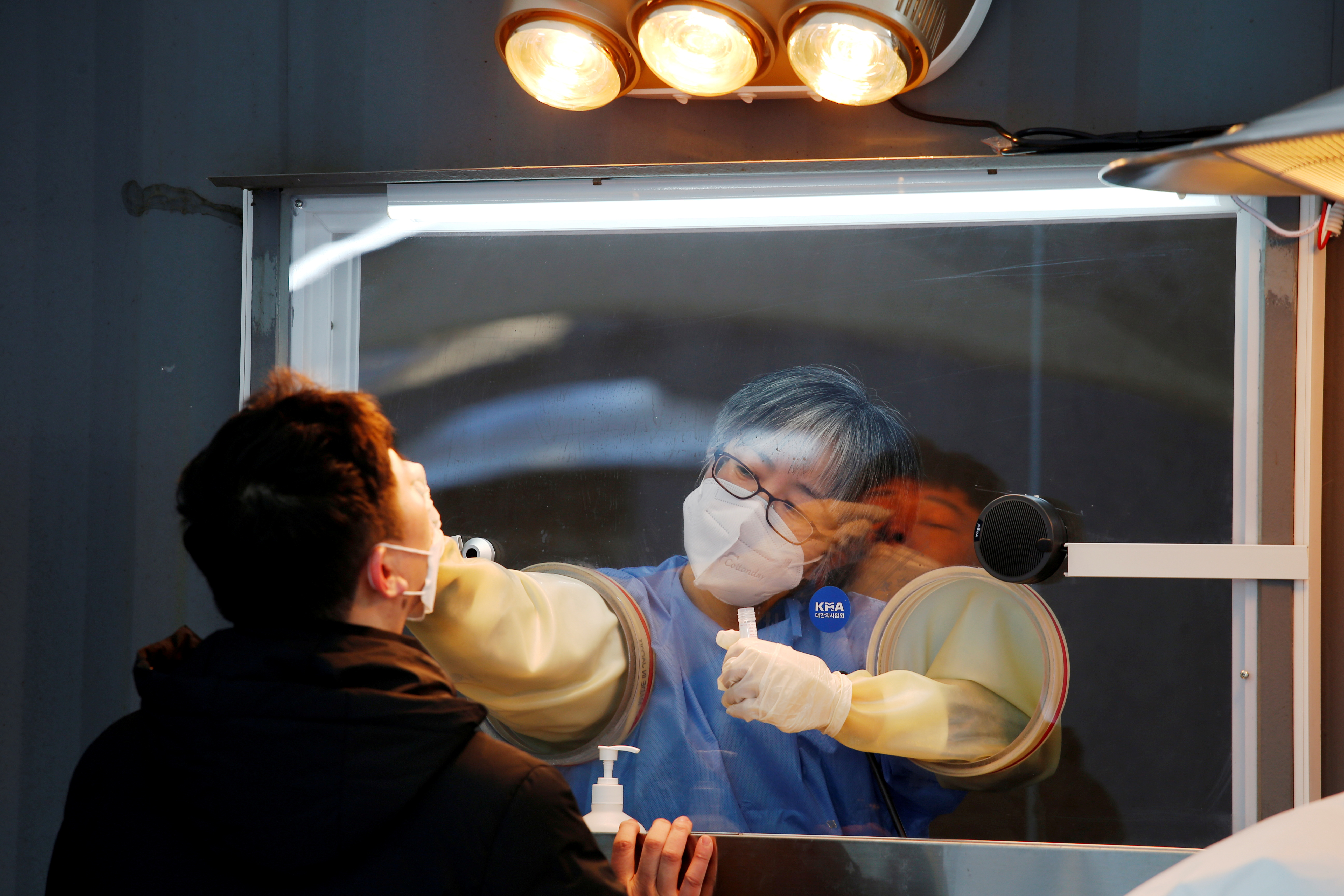 A man undergoes the coronavirus disease (COVID-19) test at a testing site at City Hall Plaza in Seoul