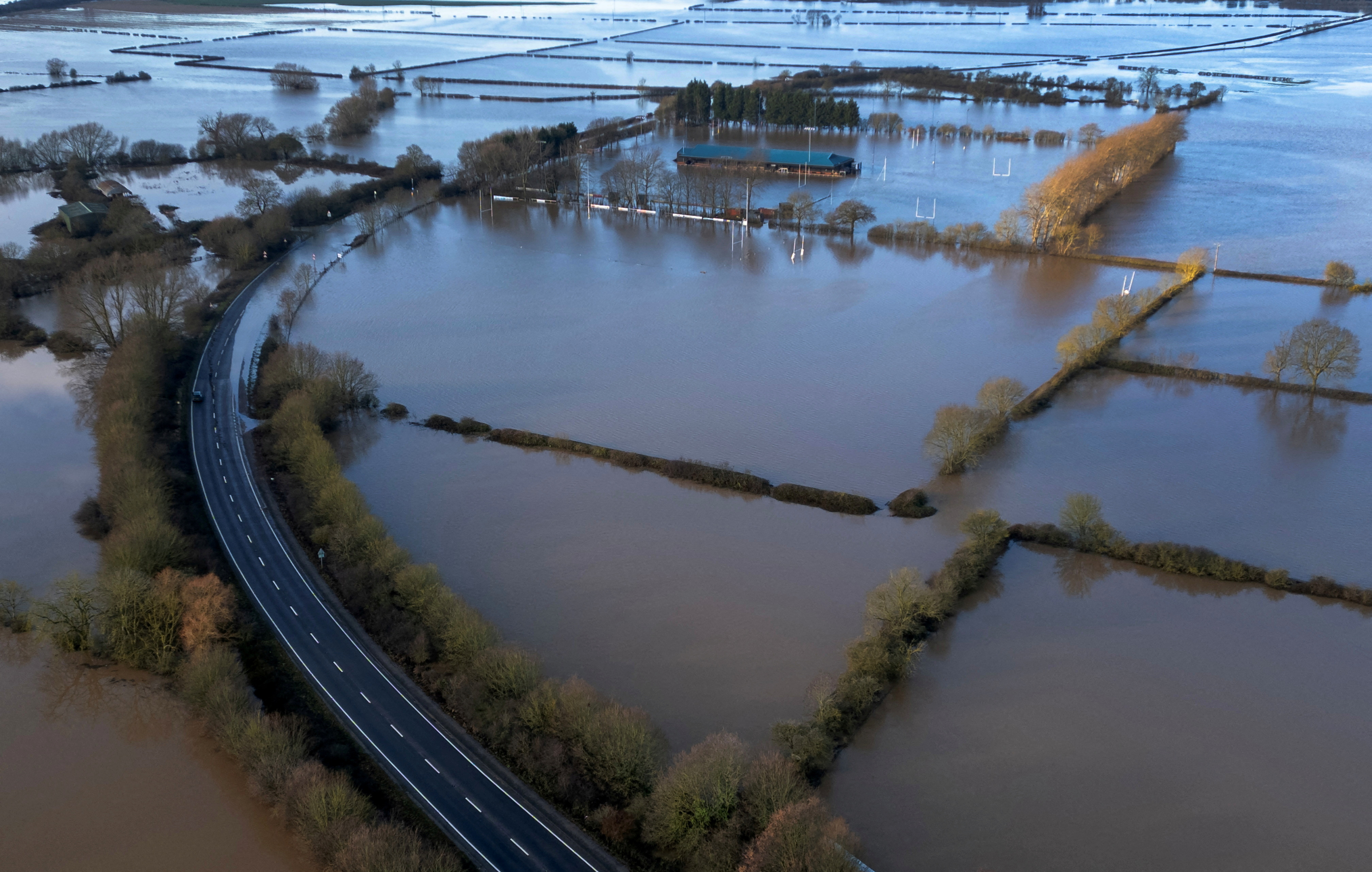 A partially closed road is surrounded by flooded fields after the River Trent burst its banks in the aftermath of Storm Henk near Newark-On-Trent