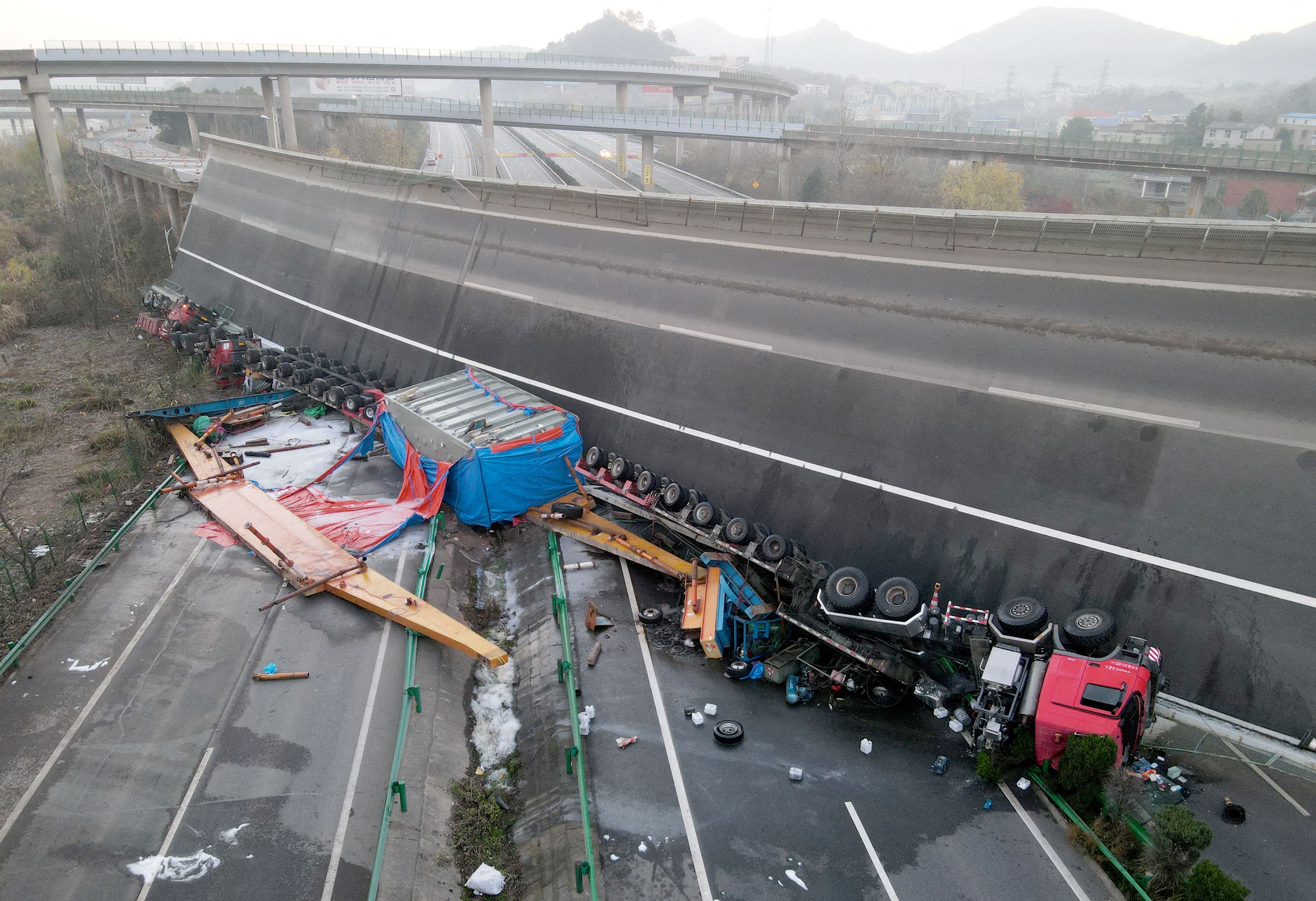 Overturned vehicles are seen at the site where a highway flyover collapsed in Ezhou