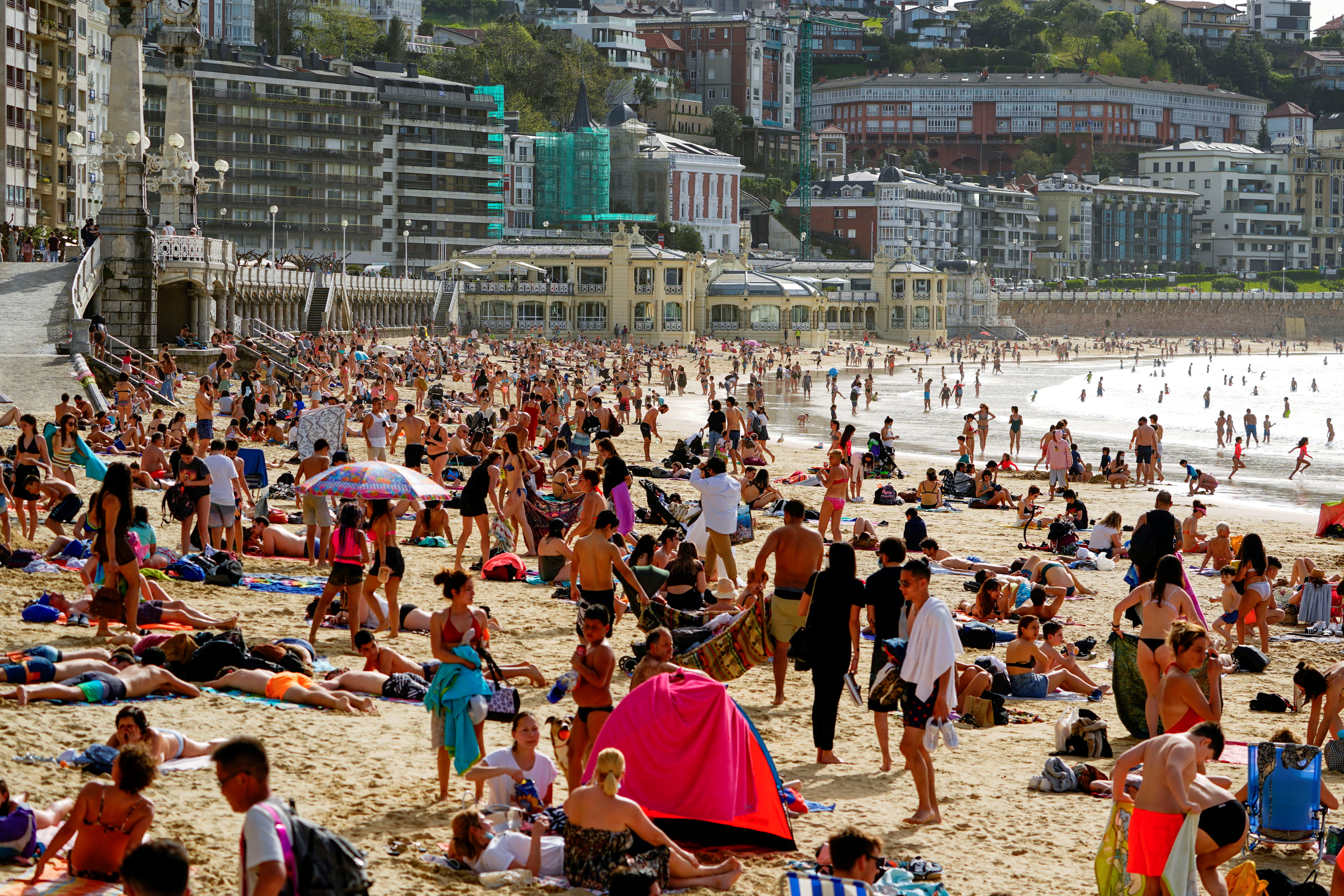 People enjoy the sun at La Concha beach after Spain introduced stricter mask laws during the coronavirus disease (COVID-19) outbreak, in San Sebastian