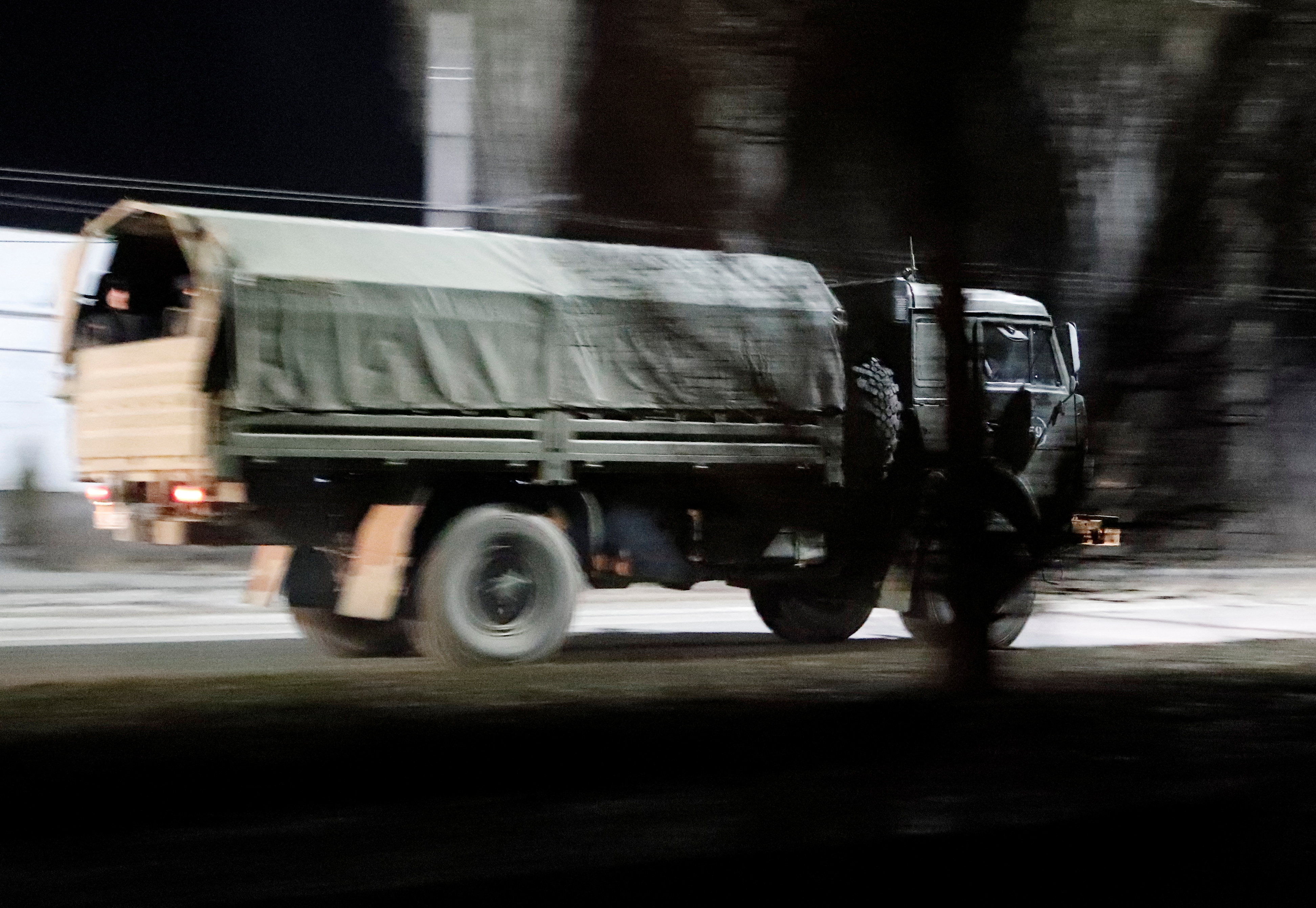 A military truck drives along a street in Donetsk