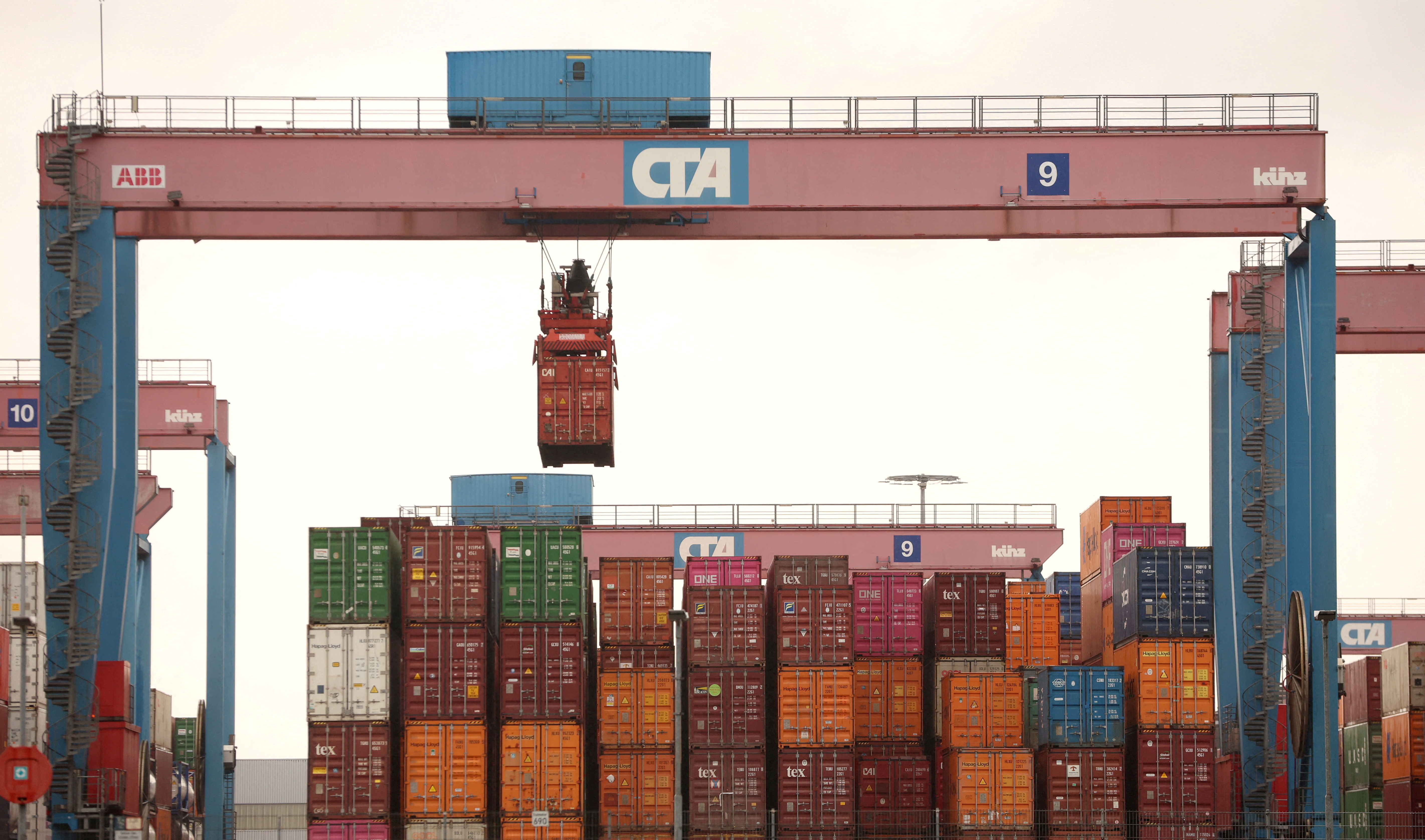 A crane lifts a shipping container at the HHLA Container Terminal Altenwerder on the Elbe River in Hamburg, Germany.