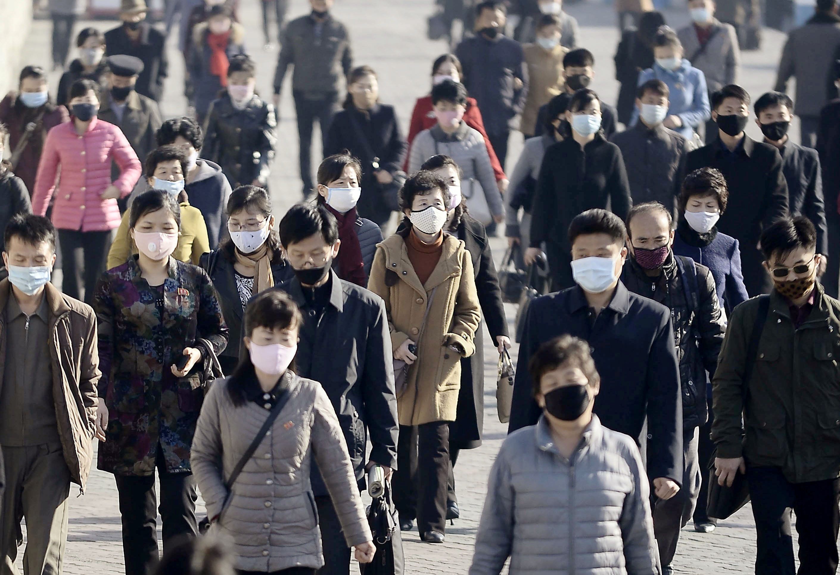 People wearing protective face masks commute amid concerns over the new coronavirus disease in Pyongyang, North Korea
