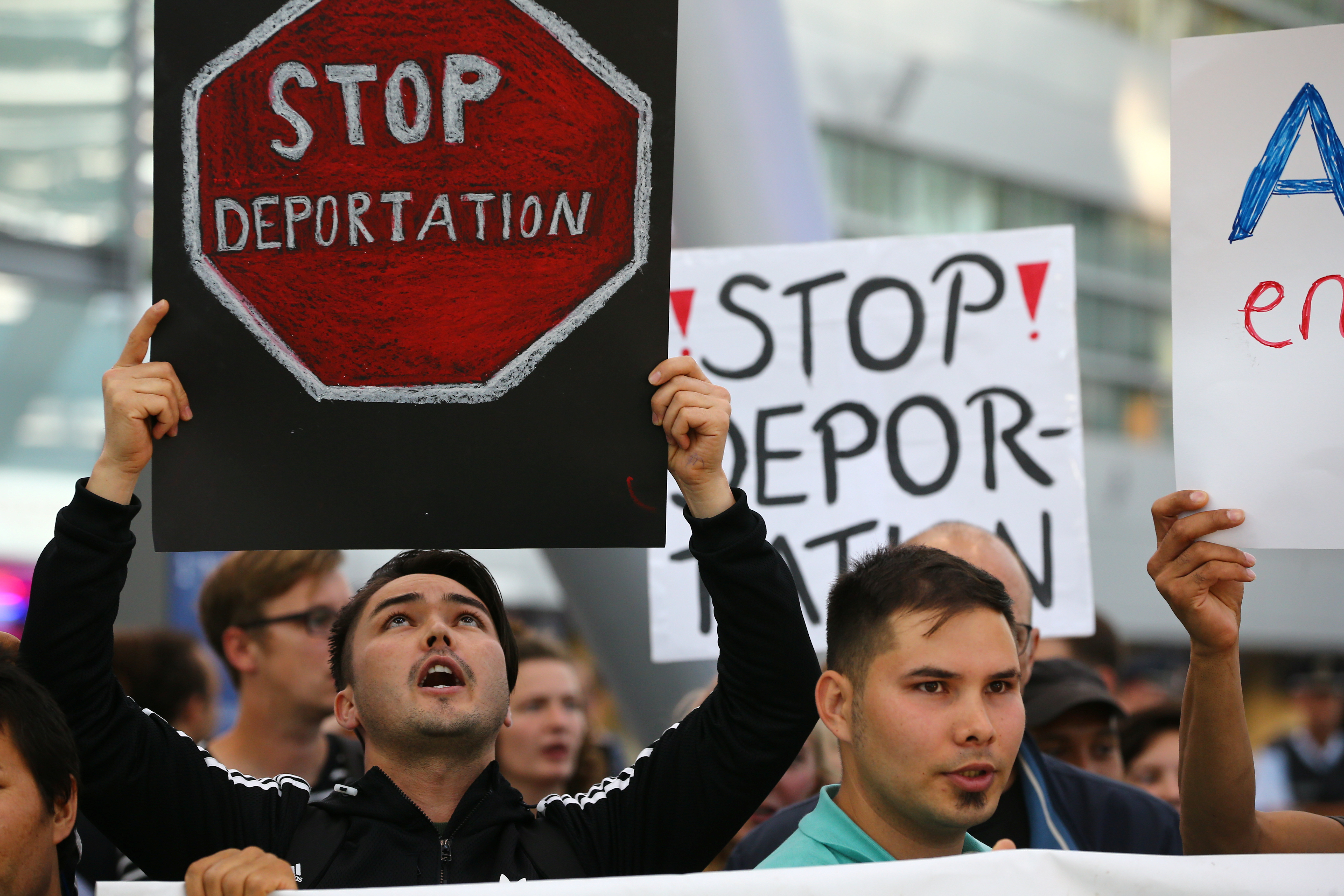 People protest against the German government's decision to deport migrants who were denied asylum, at Duesseldorf Airport