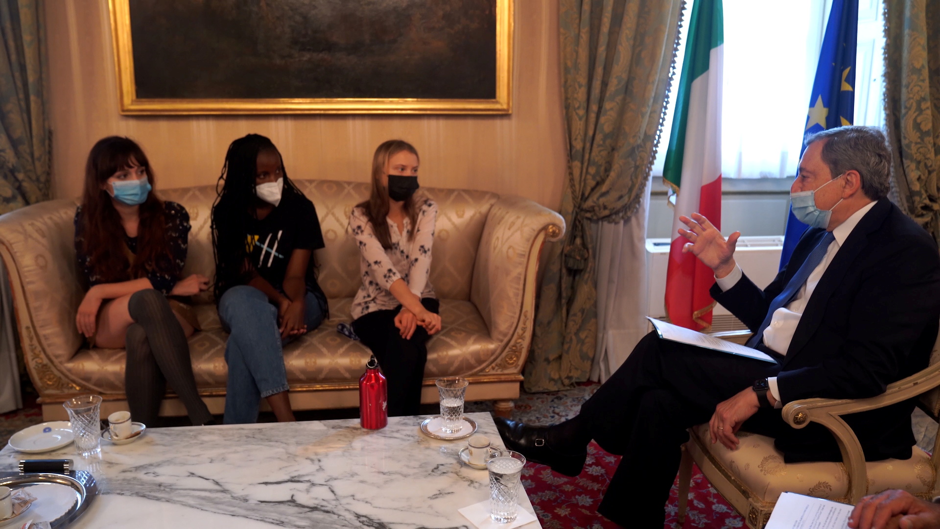 Climate activists Martina Comparelli, Vanessa Nakate and Greta Thunberg meet with Italian Prime Minister Mario Draghi ahead of the pre-COP26 ministerial meeting, in Milan, Italy, in this screen grab taken from video September 30, 2021. Palazzo Chigi Press Office/Handout via REUTERS 