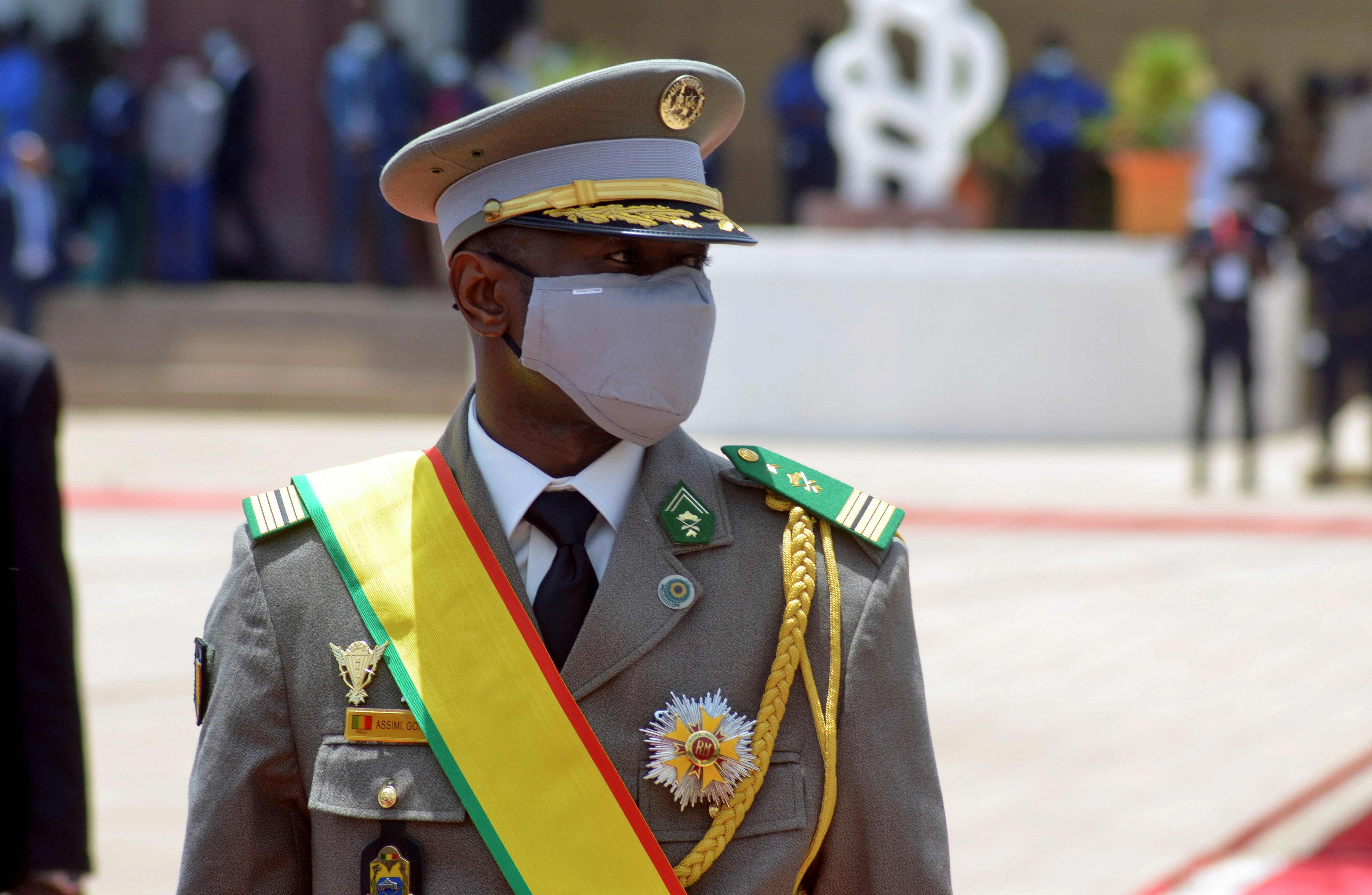 Colonel Assimi Goita, leader of two military coups and new interim president, walks during his inauguration ceremony in Bamako