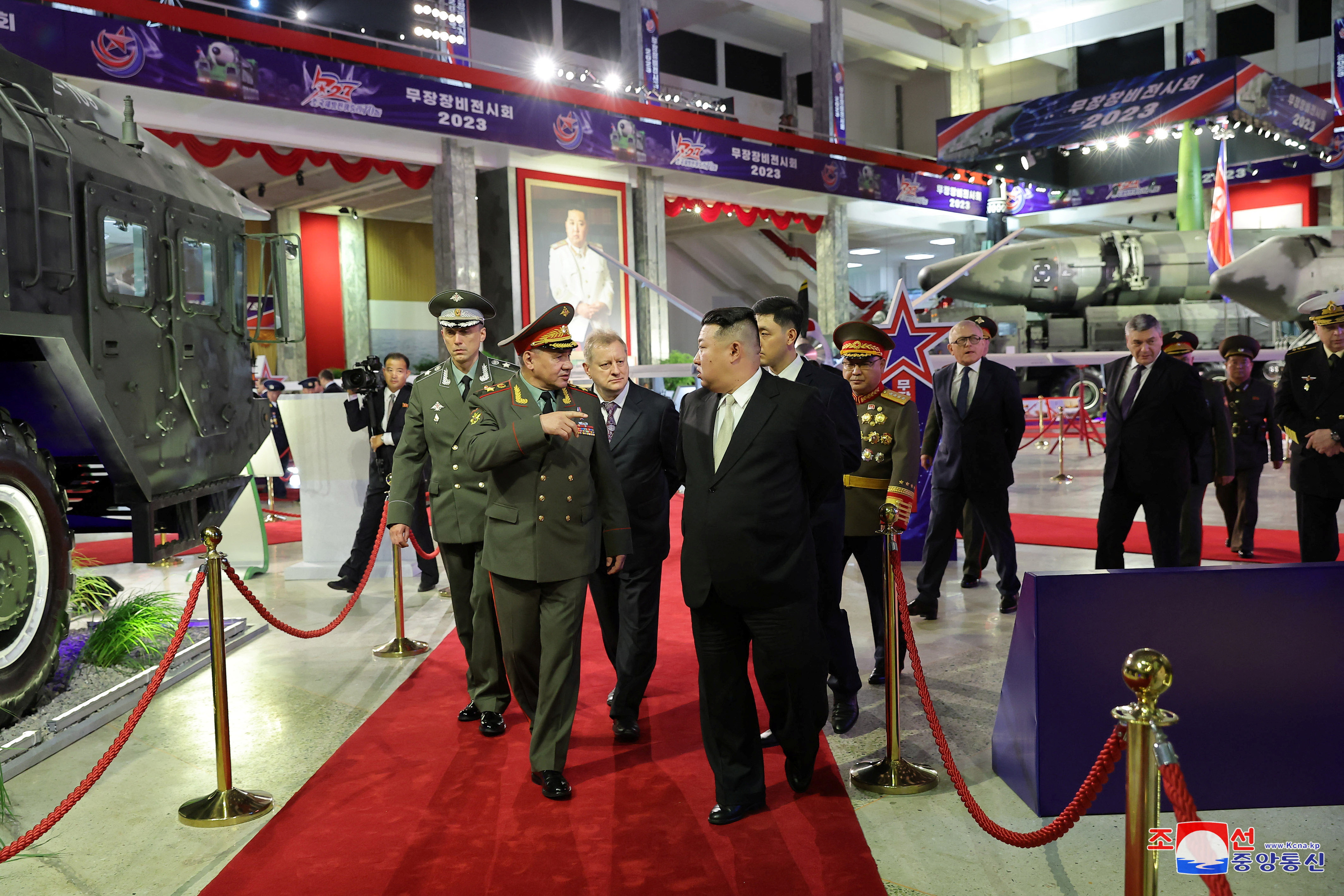 North Korean leader Kim Jong Un and Russia's Defense Minister Sergei Shoigu visit an exhibition of armed equipment