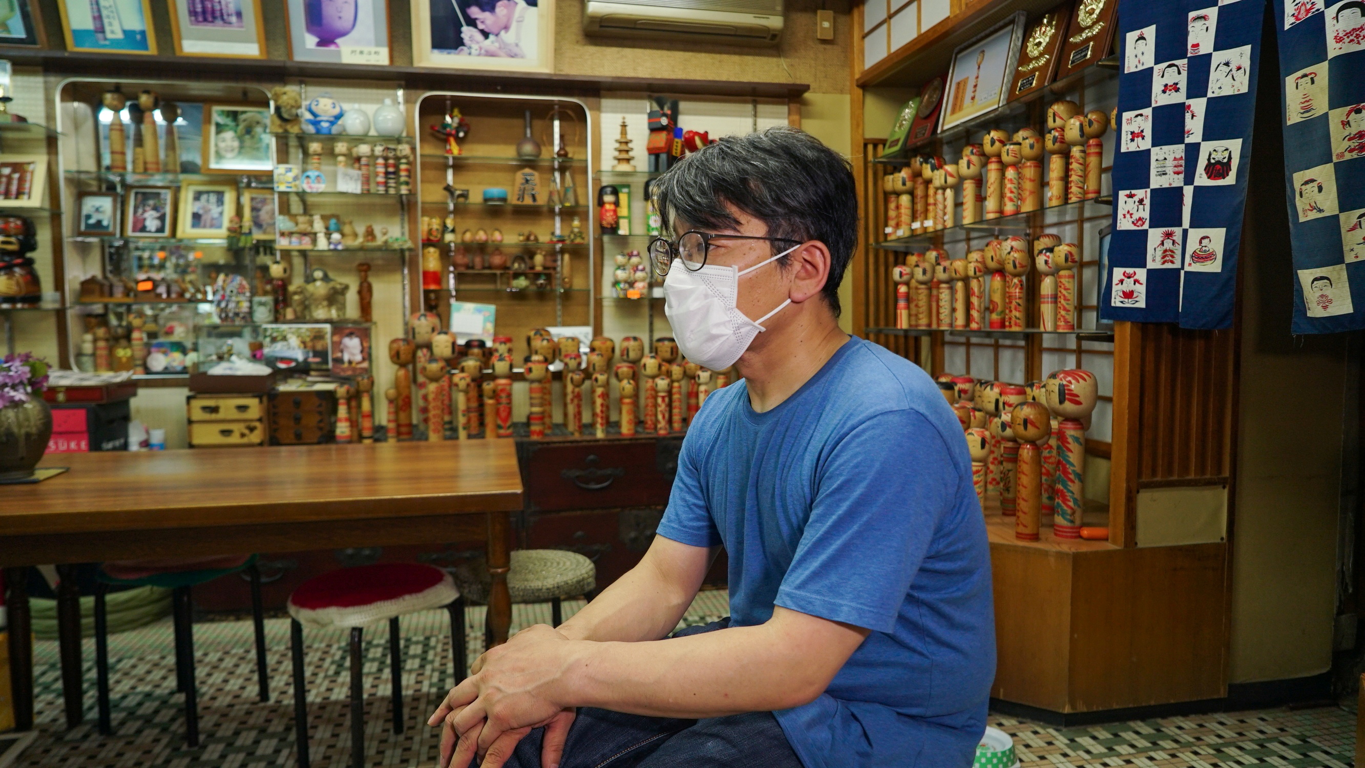 Sixth generation kokeshi maker Kunitoshi Abe sits in his shop at Tsuchiyu Onsen Machi