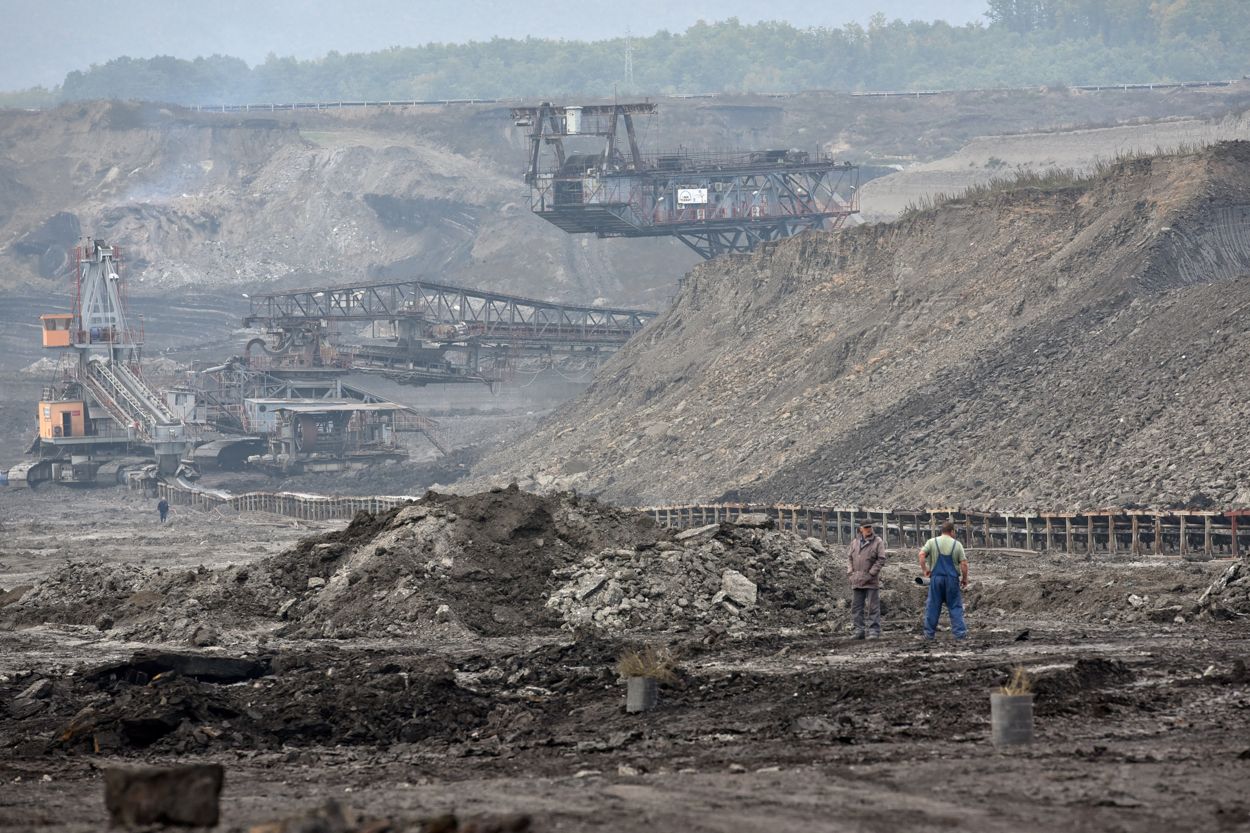 Workers stand in a lignite mine, near the town of Obiliq