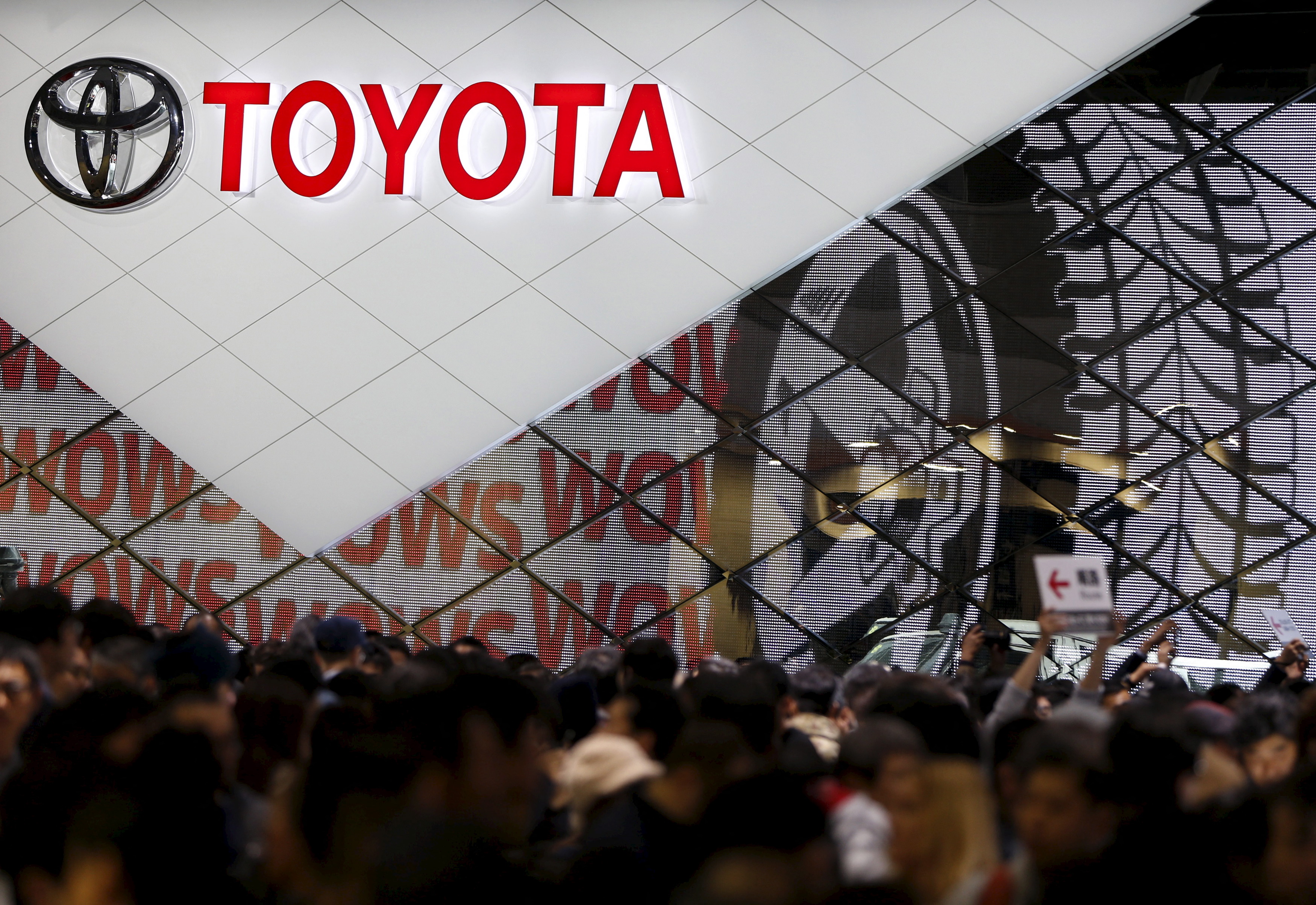 Visitors crowd Toyota Motor Corp's booth at the 44th Tokyo Motor Show in Tokyo, Japan
