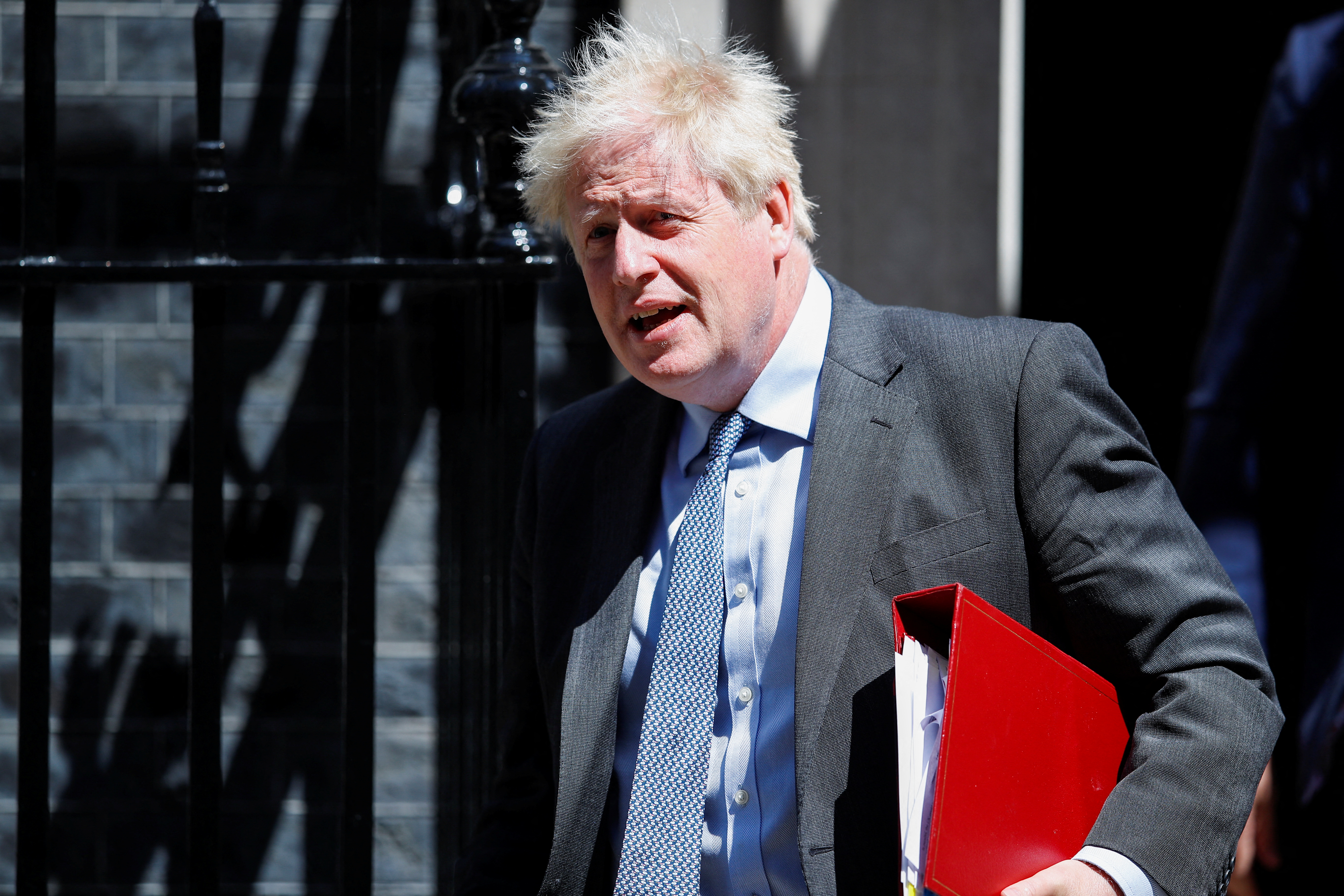 British PM Johnson leaves 10 Downing Street to take questions in parliament, in London