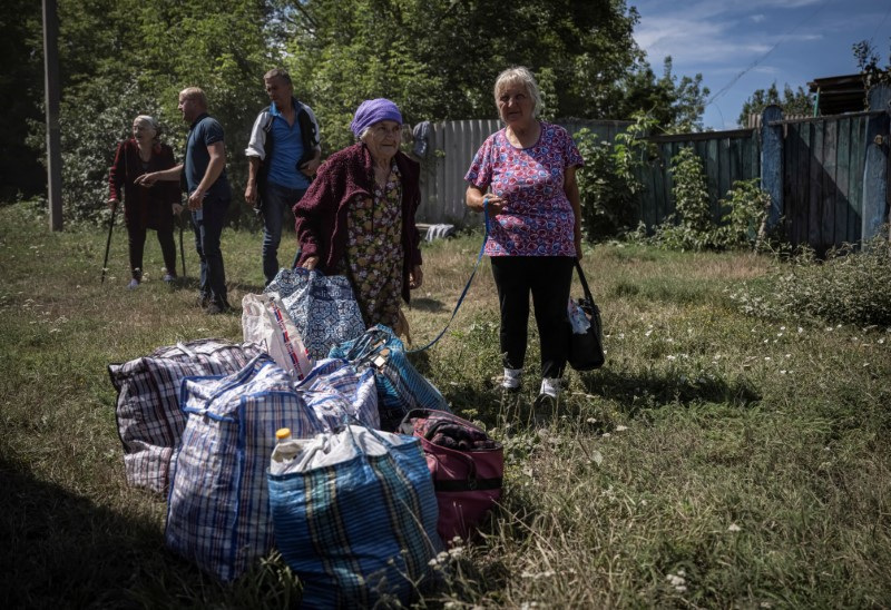 Local residents from a village near the Russian border during an evacuation to Sumy