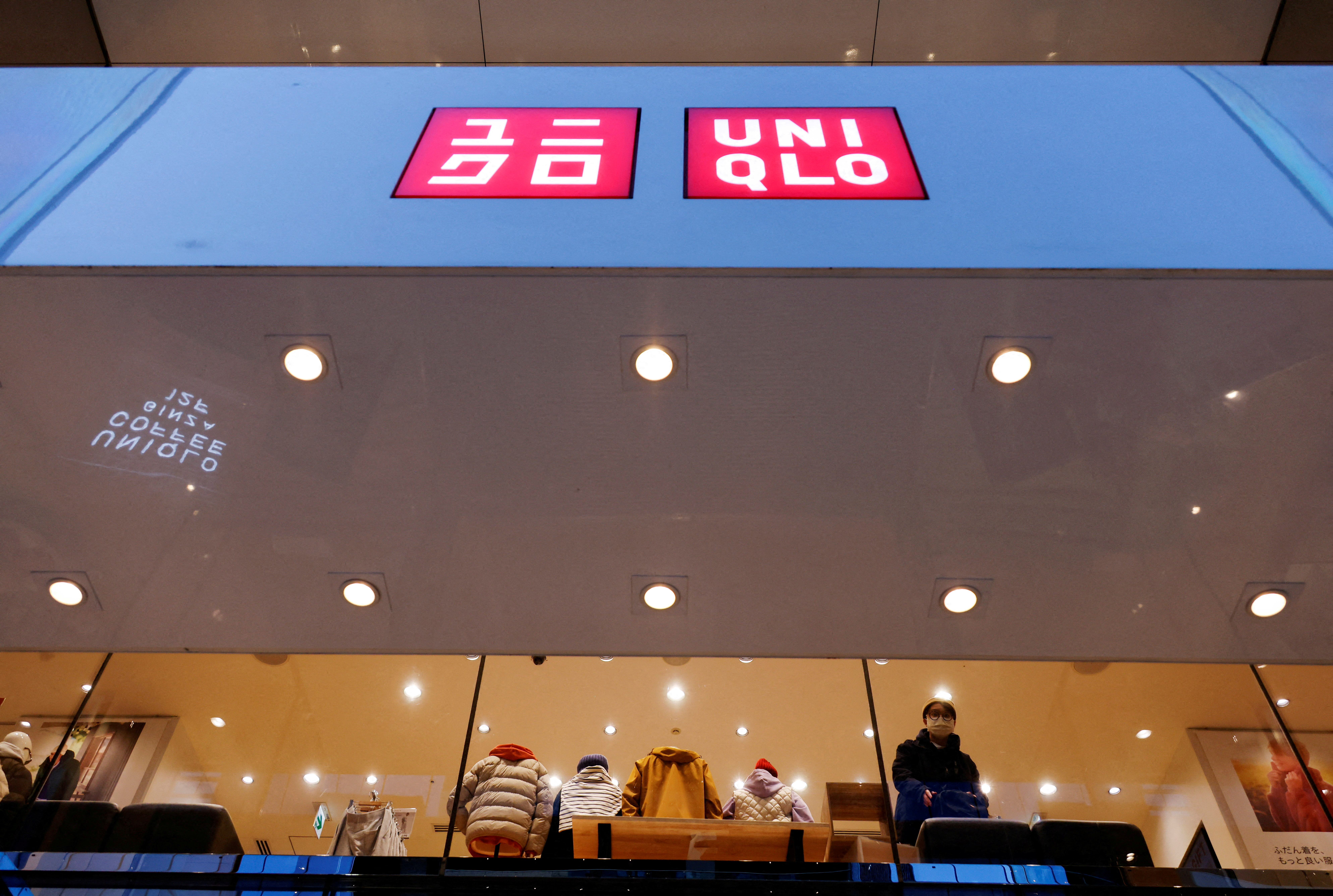 A shopper looks on, inside a Fast Retailing's Uniqlo casual clothing store in Tokyo