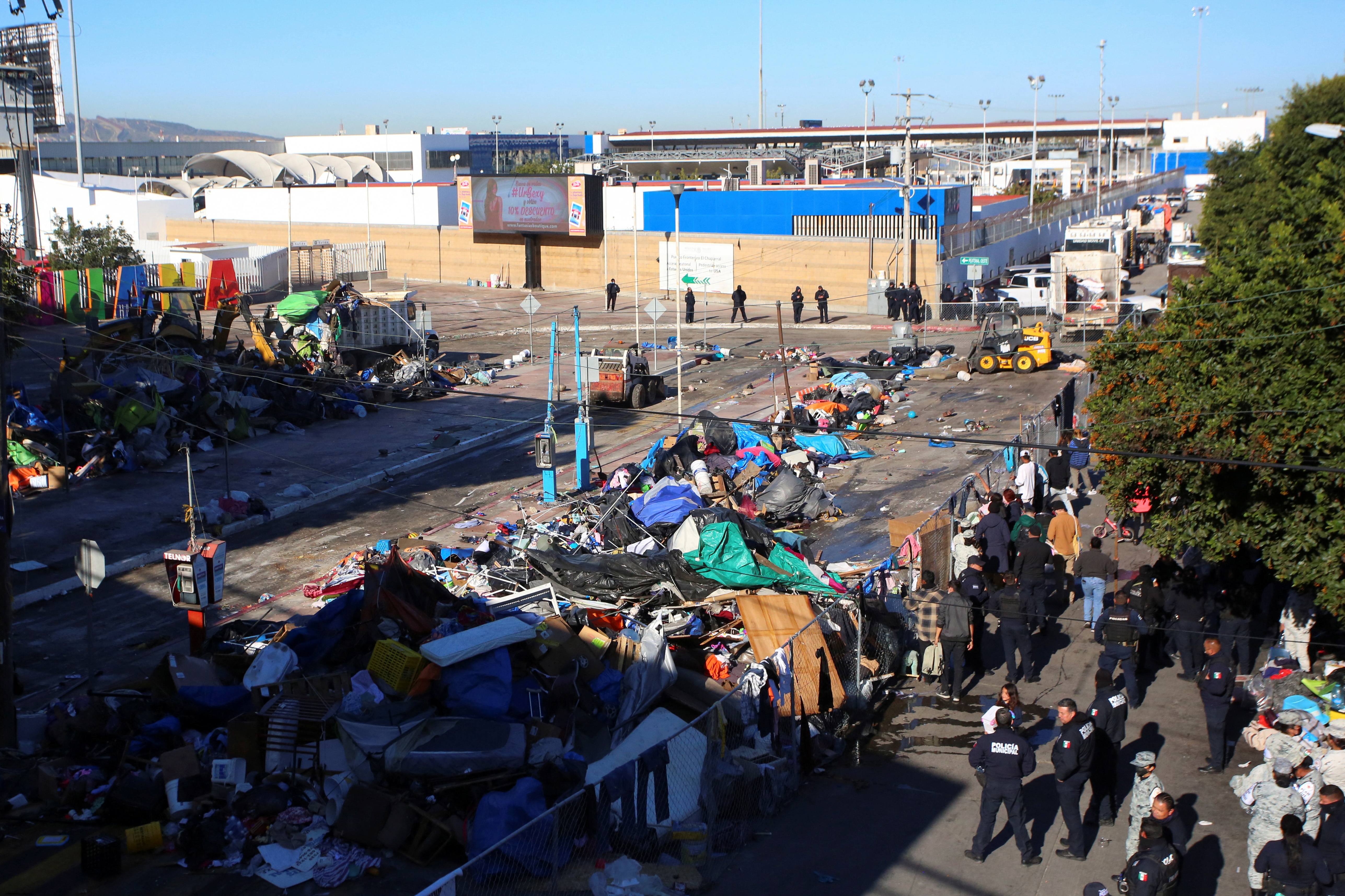 Belongings of migrants are scattered, after Mexican authorities cleared a makeshift camp, where hundreds of people heading towards the U.S. border were staying, at the El Chaparral border crossing in Tijuana, Mexico, February 6, 2022. REUTERS/Jorge Duenes