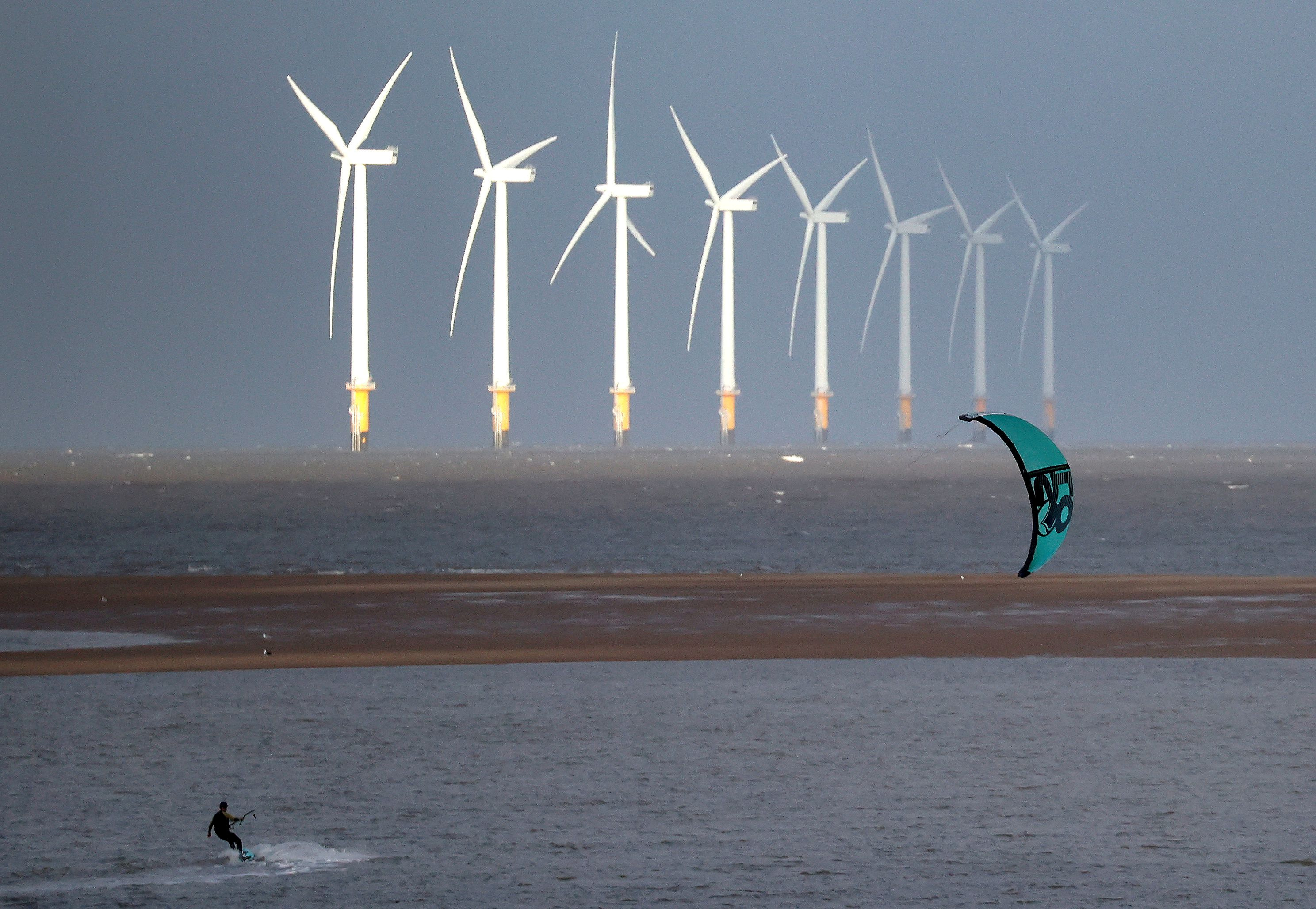 FILE PHOTO: A kite surfer is pictured in front of the Burbo Bank offshore wind farm near New Brighton