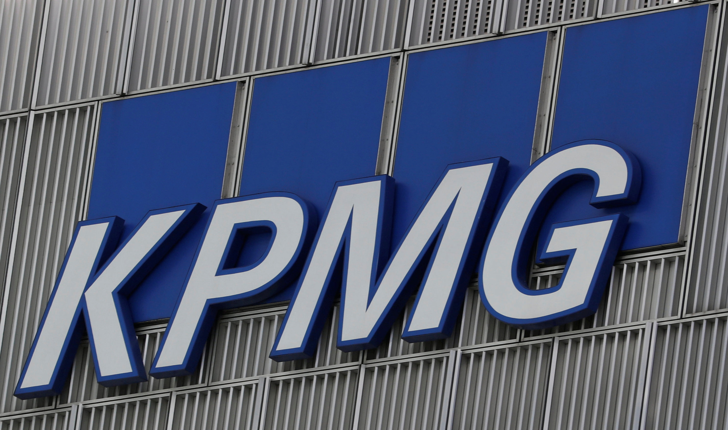 The KPMG logo is seen at their offices at Canary Wharf financial district in London