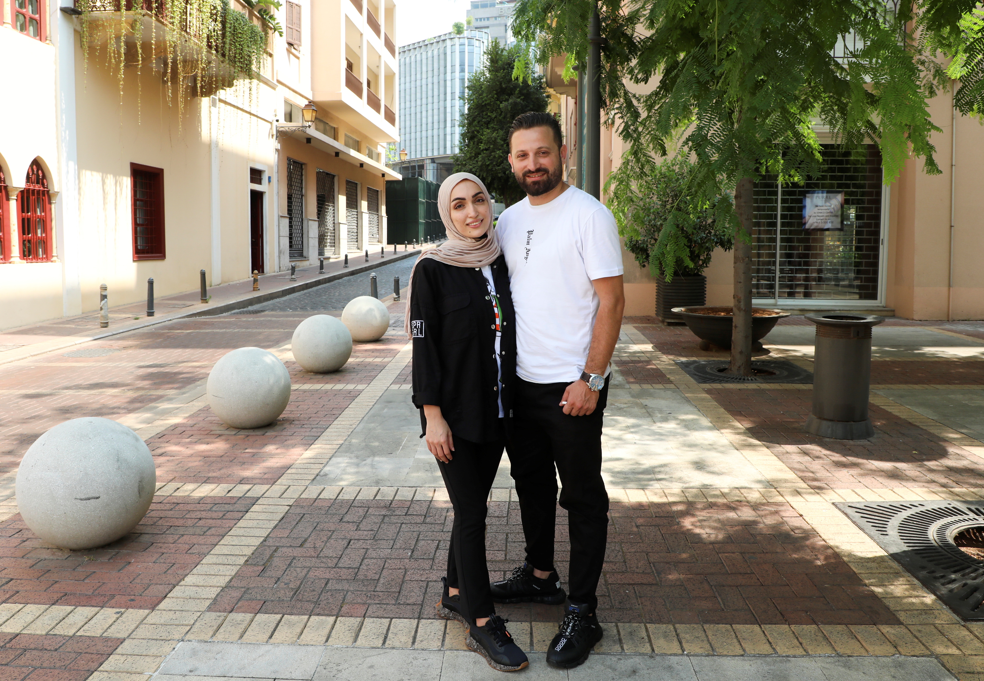 Israa Seblani, a Lebanese doctor and the bride who was caught up in the last year's Beirut port blast during a wedding photoshoot, poses for a picture with her husband Ahmad Subeih