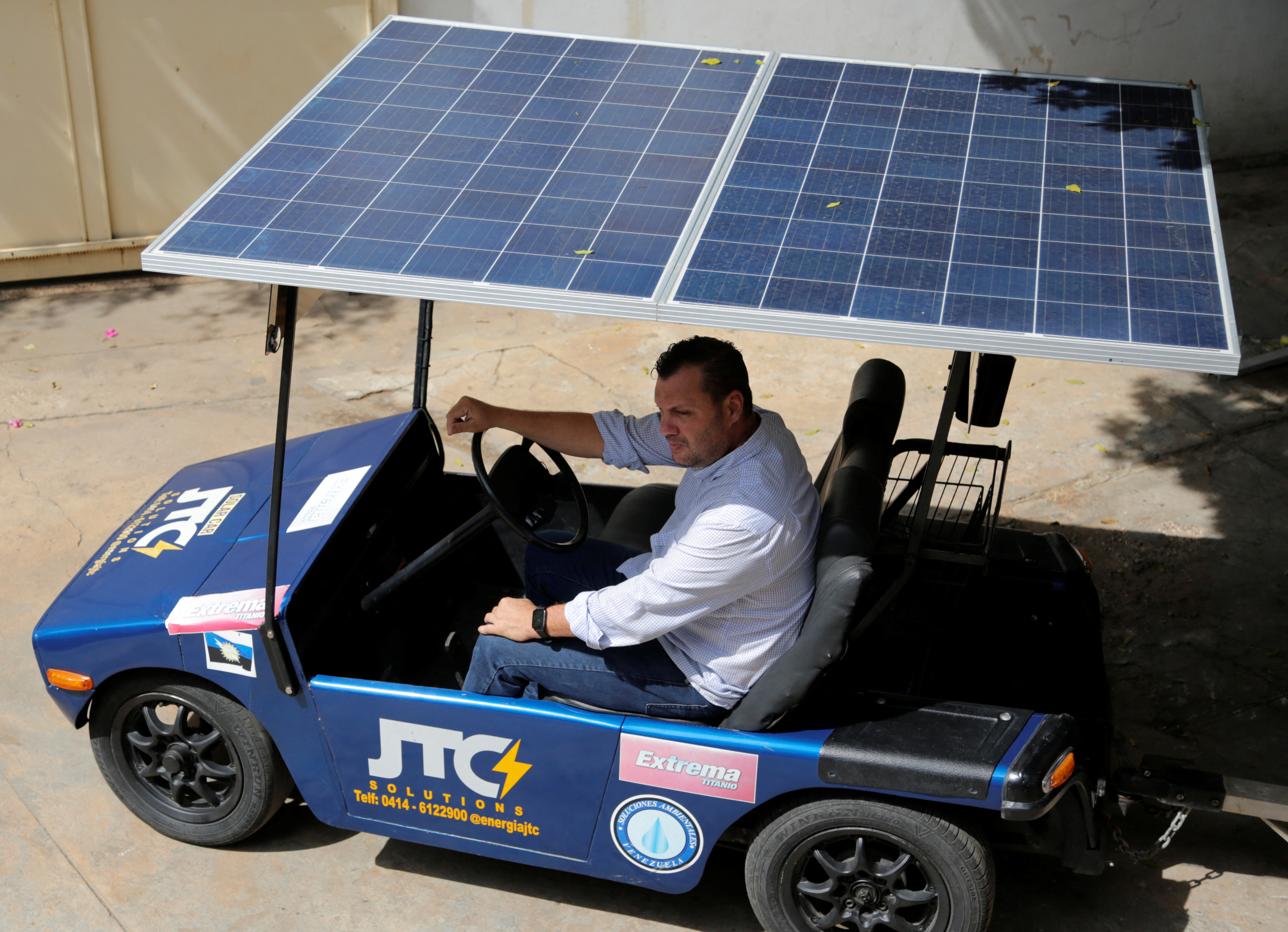 In Venezuelan oil town, solar-powered car offers escape from fuel lines