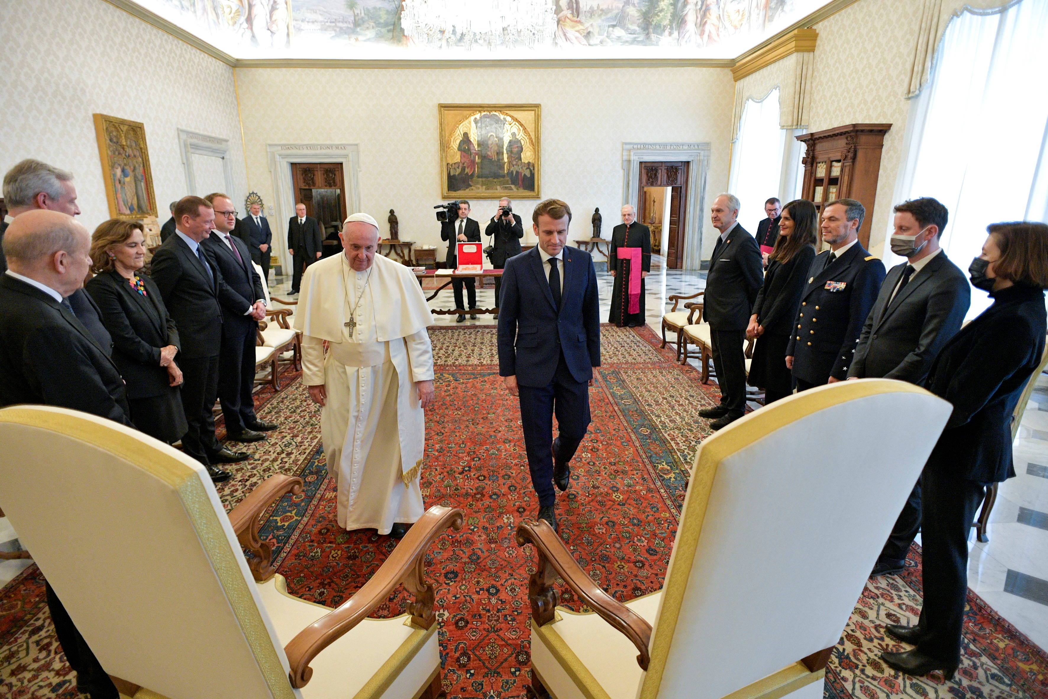 Pope Francis walks with French President Emmanuel Macron during a meeting at the Vatican, November 26, 2021. Vatican Media/Handout via REUTERS  