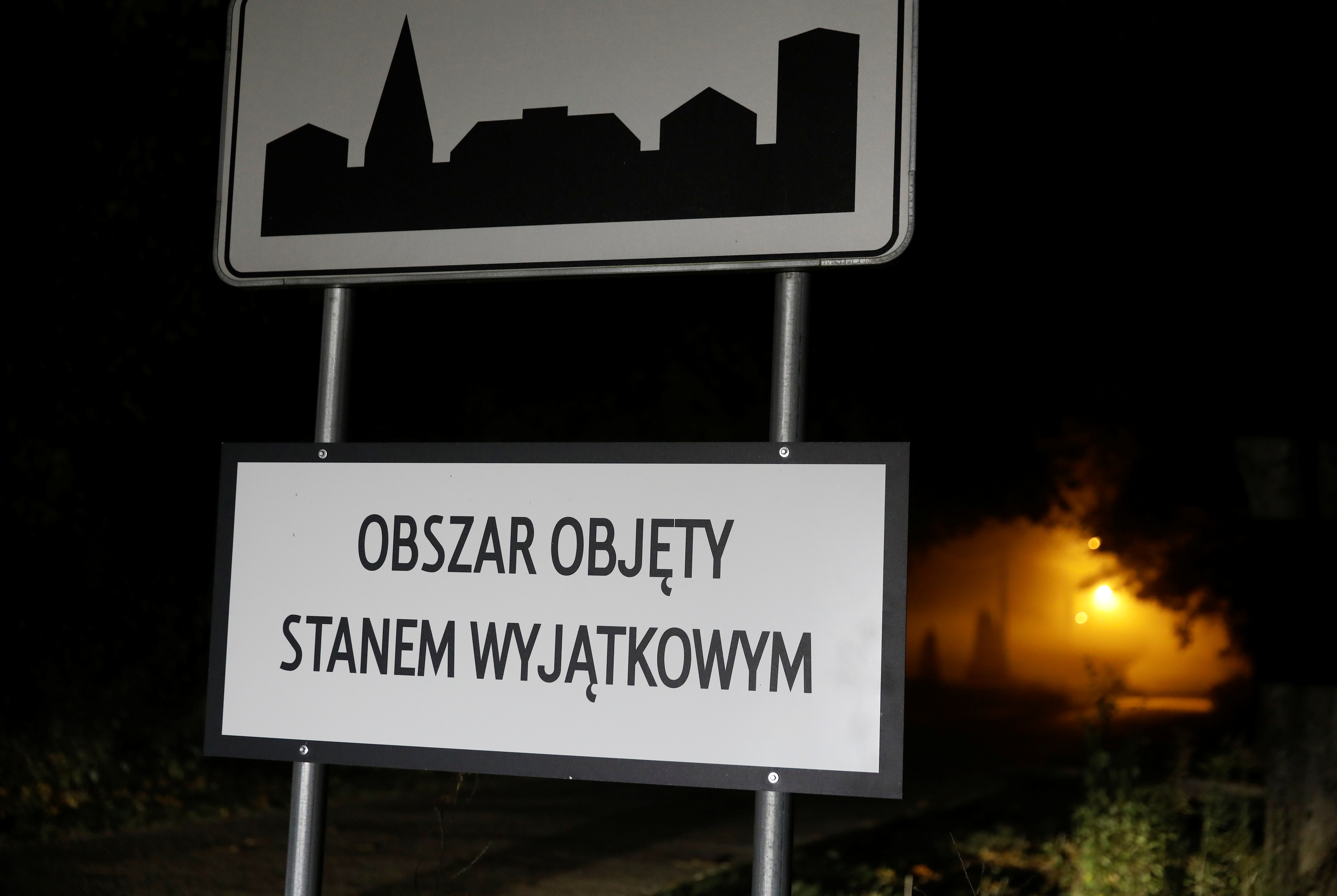 Road sign with 'Area covered by a state of emergency' is seen near Belarusian-Polish border in Nowosady, Poland October 12, 2021. Picture taken October 12, 2021. REUTERS/Kacper Pempel