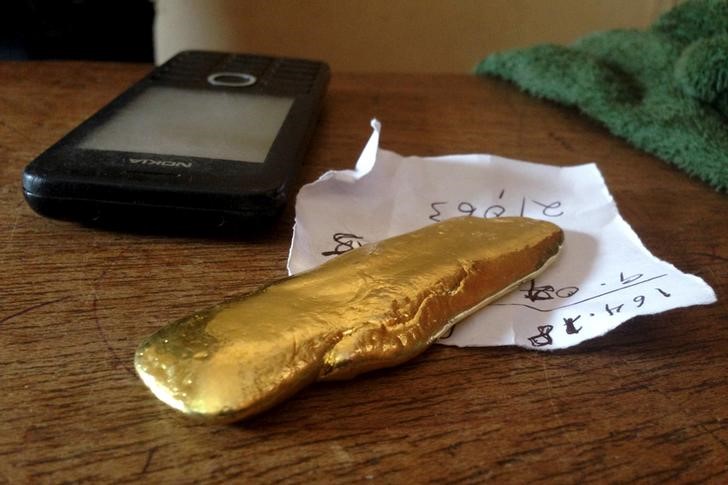 A brick of gold is seen on an artisanal trader's desk in Tarkwa