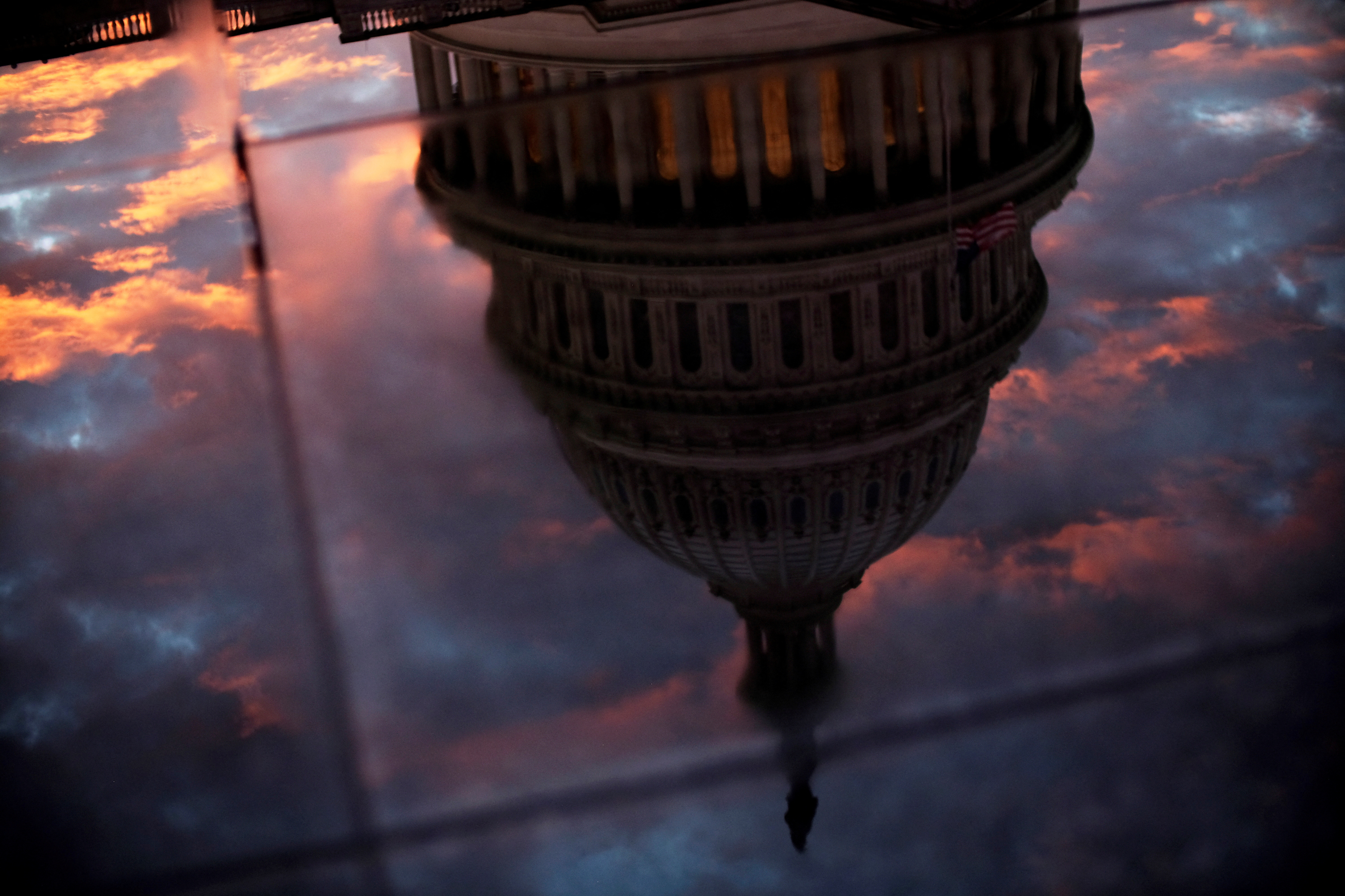 The U.S. Capitol dome is reflected in the glass skylight of the Capitol Visitor Center in Washington