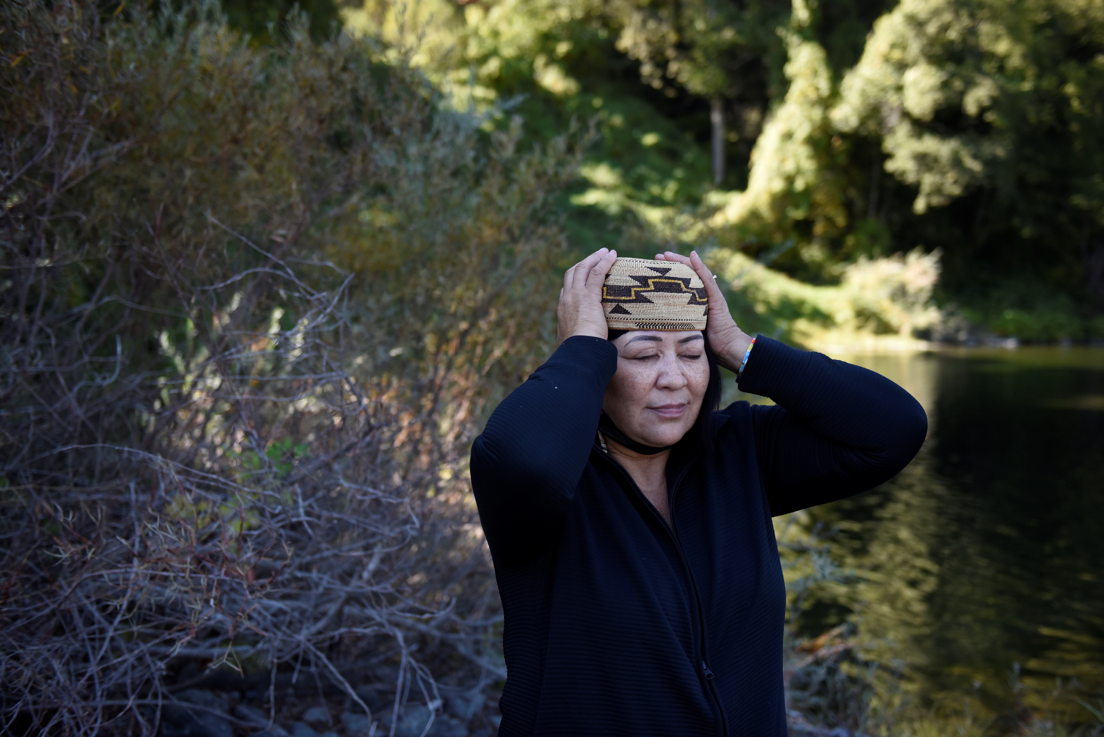 Jill Sherman-Warne, 55, places a traditional cap on her head on the Hoopa Valley Reservation.  REUTERS/Stephanie Keith 