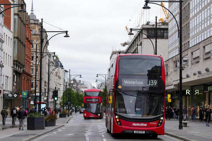 Iconic red double-decker bus rides at the Regent Street
