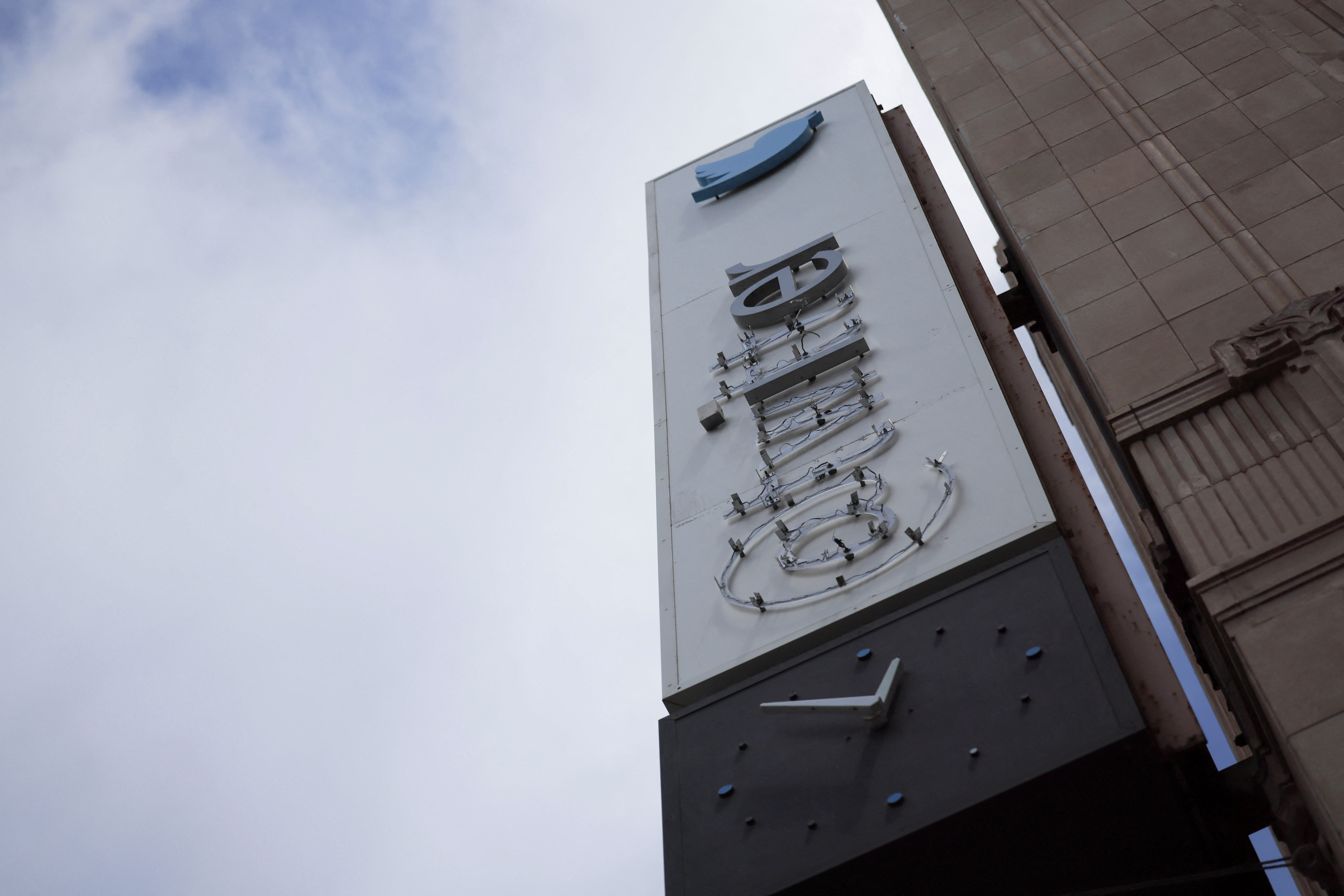 A partially dismantled Twitter's sign is seen at Twitter's corporate headquarters building in San Francisco