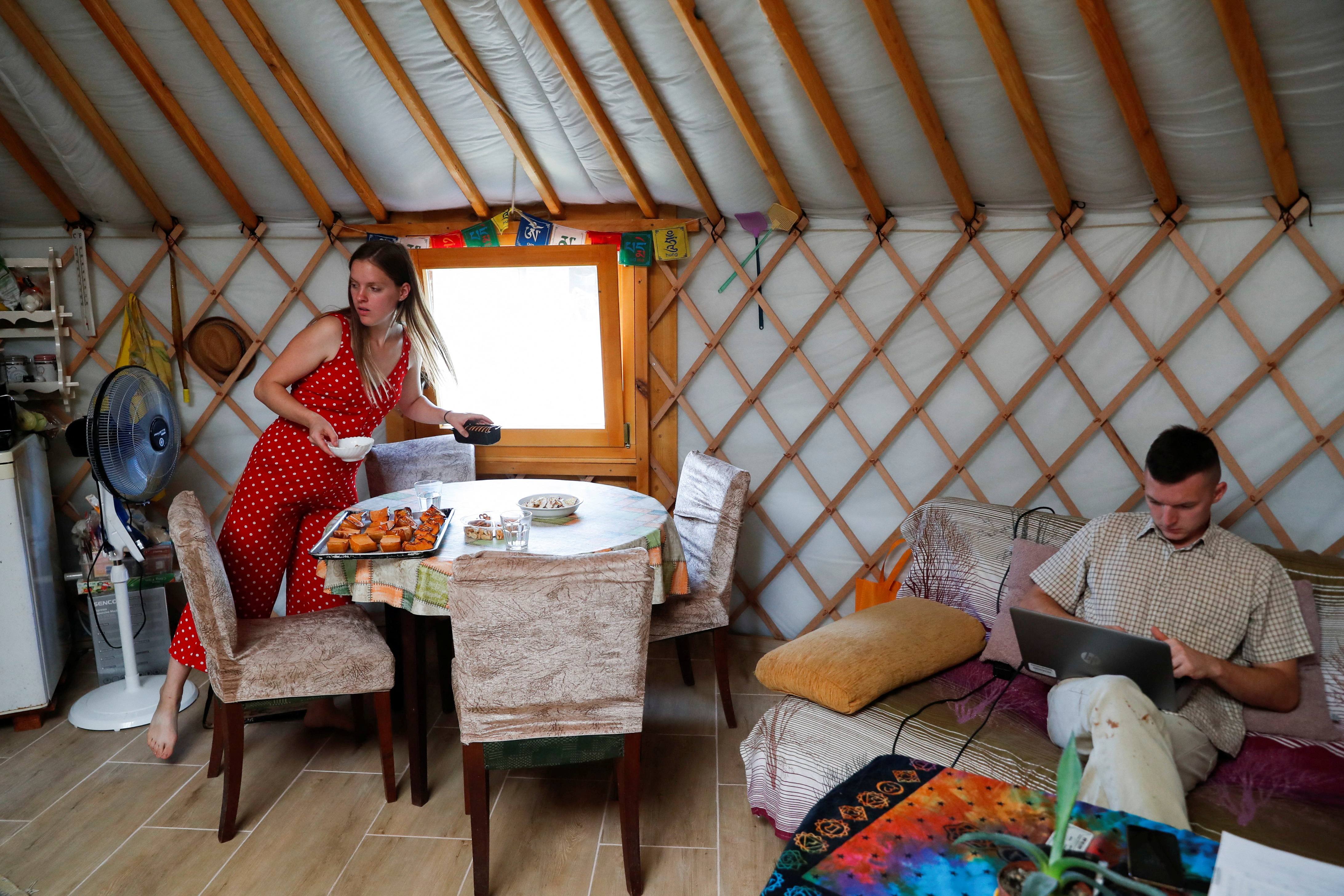 Petra Pogany-Bago prepares lunch as her husband Mihaly works in their yurt tent near Kecskemet