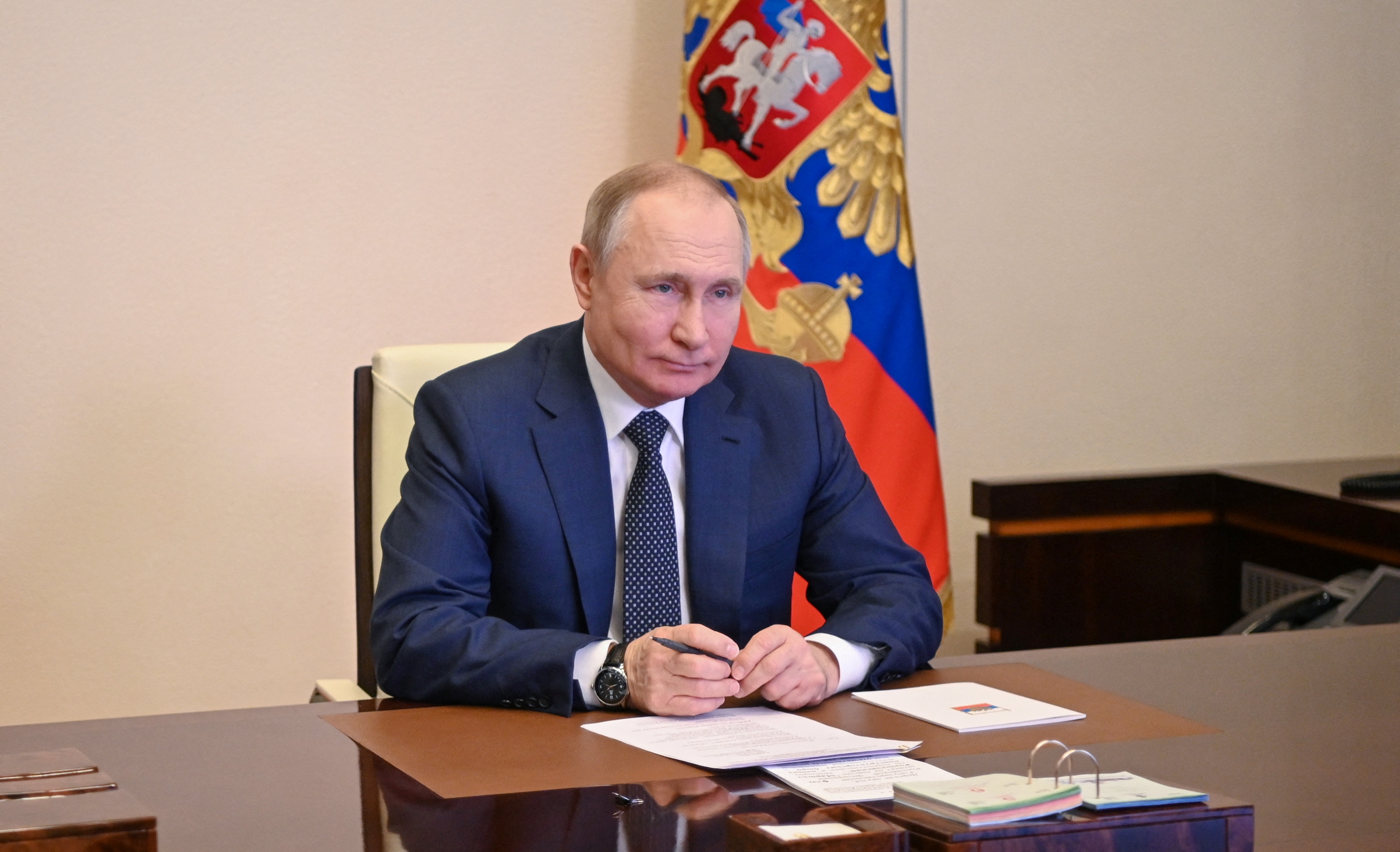 Russian President Putin takes part in a video link outside Moscow