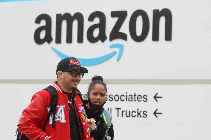 Amazon workers walk outside Amazon’s LDJ5 sortation center in Staten Island, New York