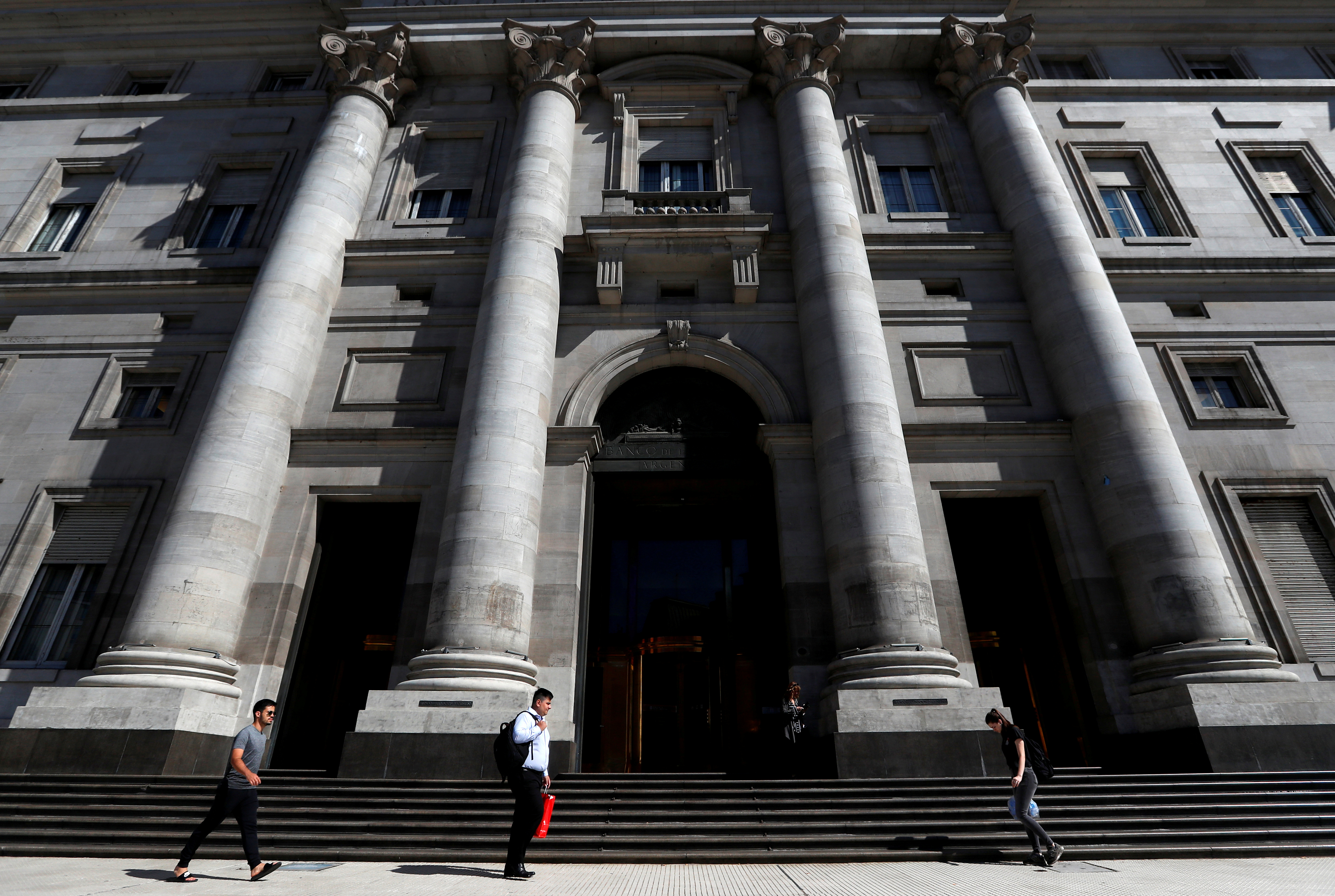 Pedestrians walk past the facade of Argentina's Banco Nacion (National Bank), in Buenos Aires, Argentina February 19, 2020. Picture taken February 19, 2020. REUTERS/Agustin Marcarian/File Photo