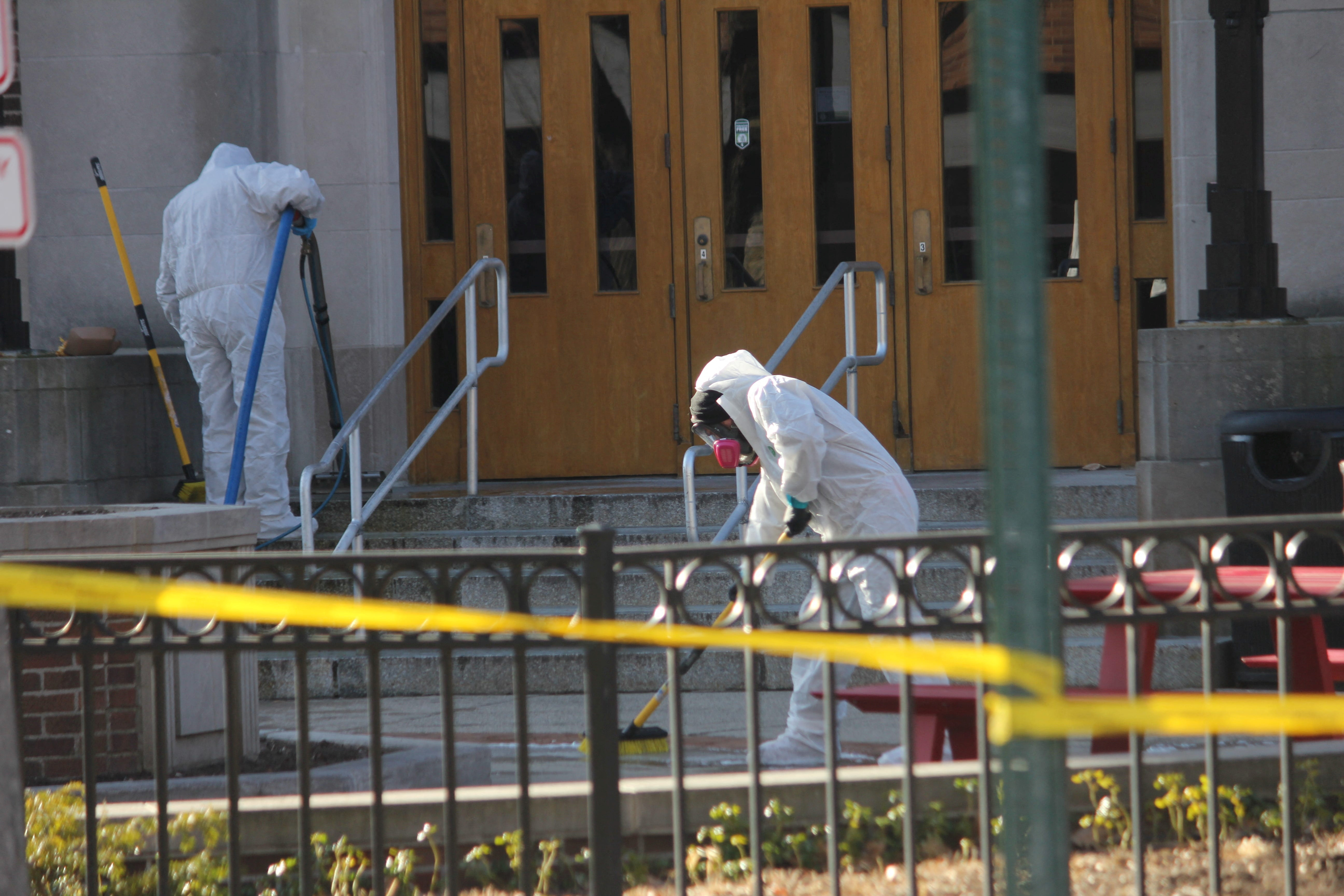 Workers from Belfor Property Restoration clean the front steps after Michigan State University shooting