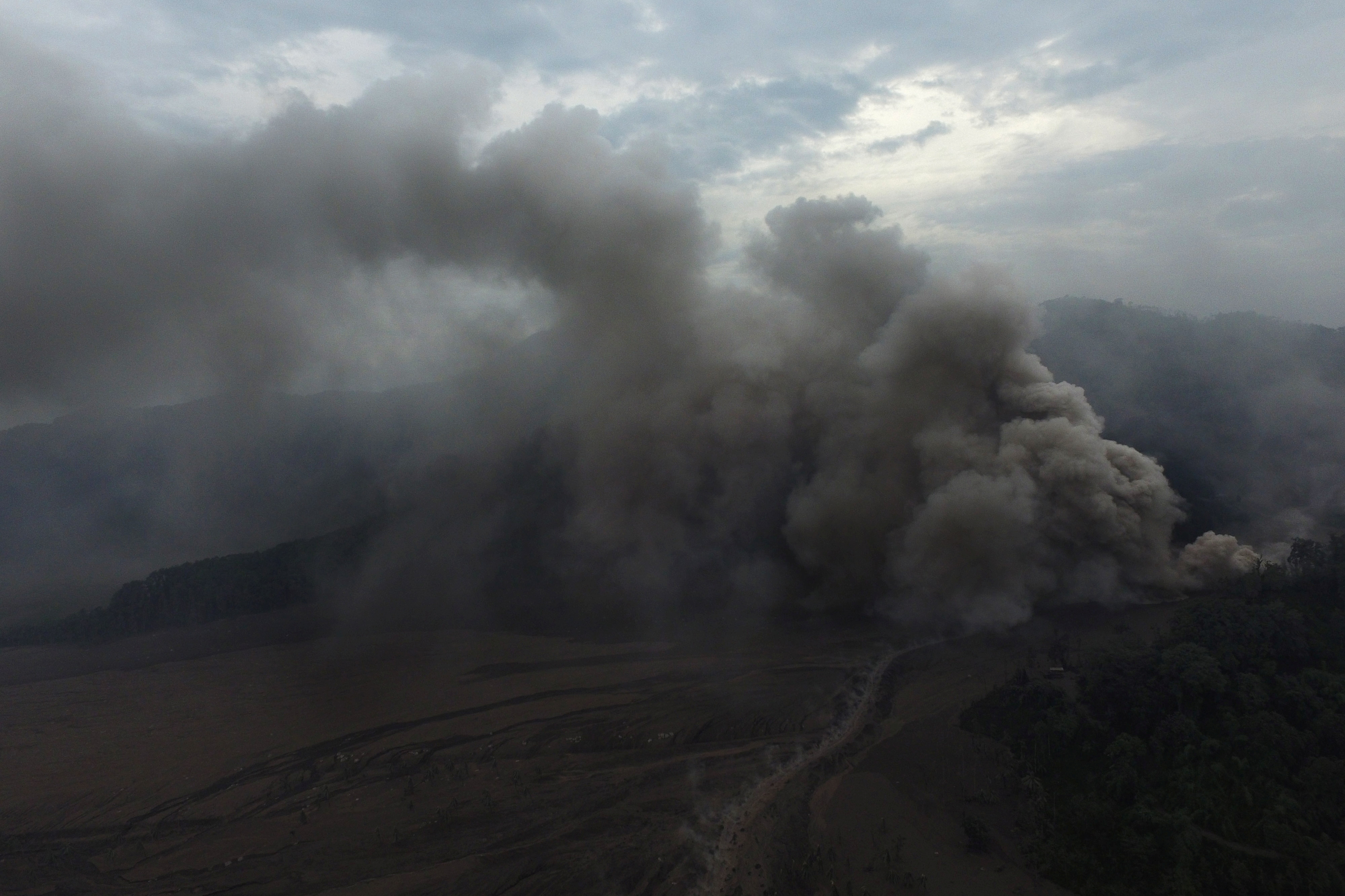 An aerial view shows volcanic ash rising affected by the Mount Semeru volcano during an eruption in Sumber Wuluh village