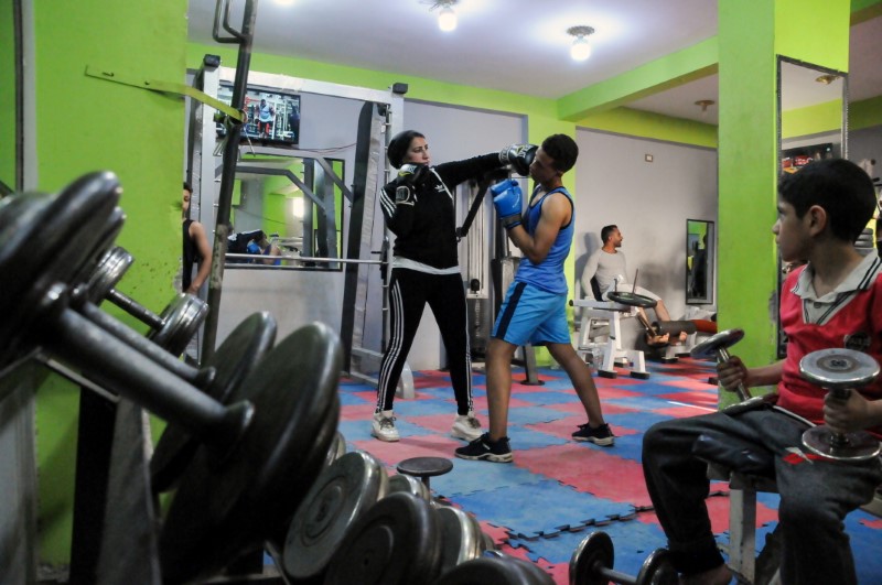 Sabah Saqr, an Egyptian boxing coach challenges social boundaries by training men, is seen during a training session at the gym, in Bani Swief