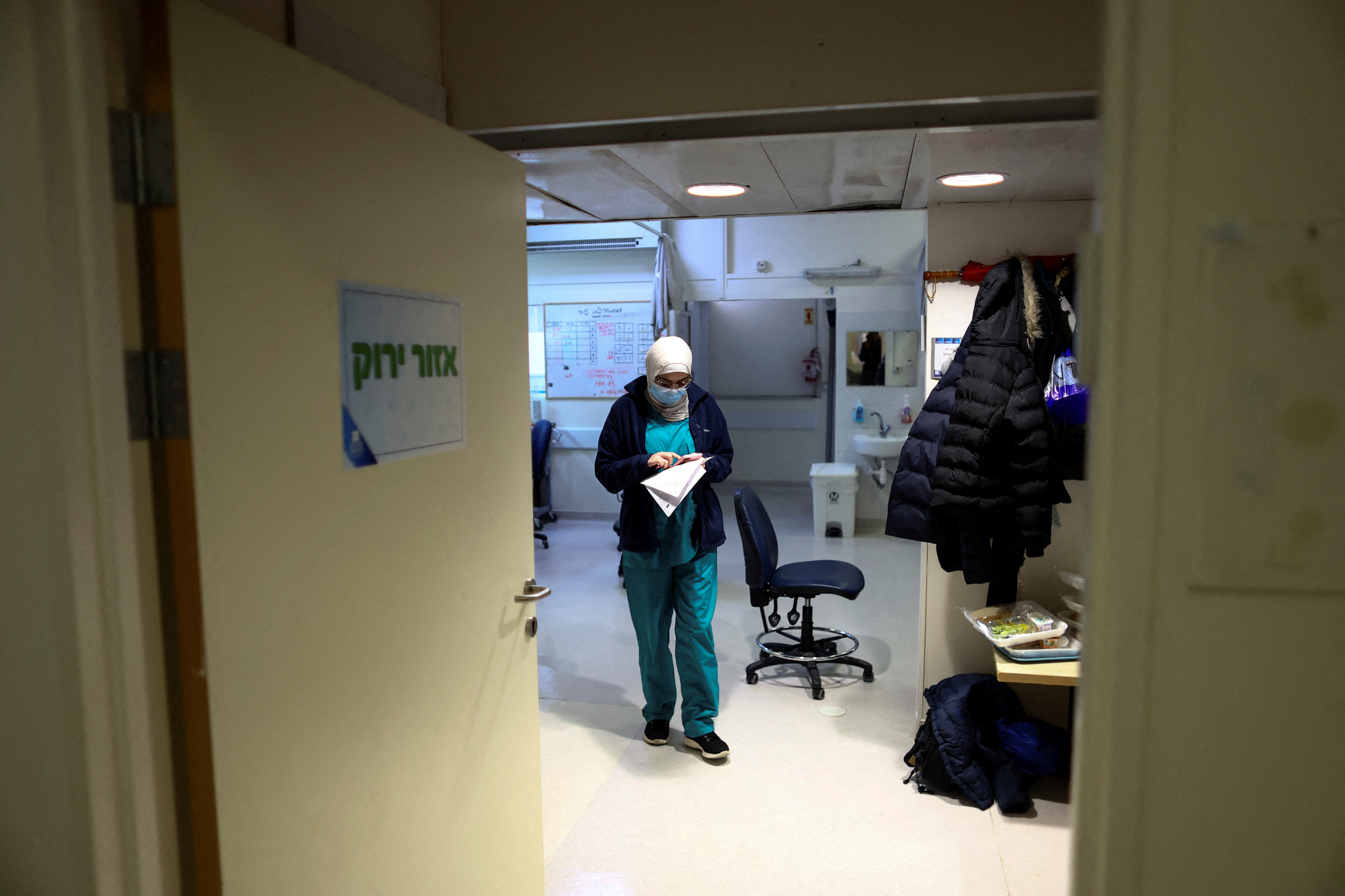 A medical staff member uses her mobile phone in the "green zone" area of the coronavirus disease (COVID-19) ward at Hadassah Ein Kerem Hospital, in Jerusalem January 31, 2022. REUTERS/Ronen Zvulun