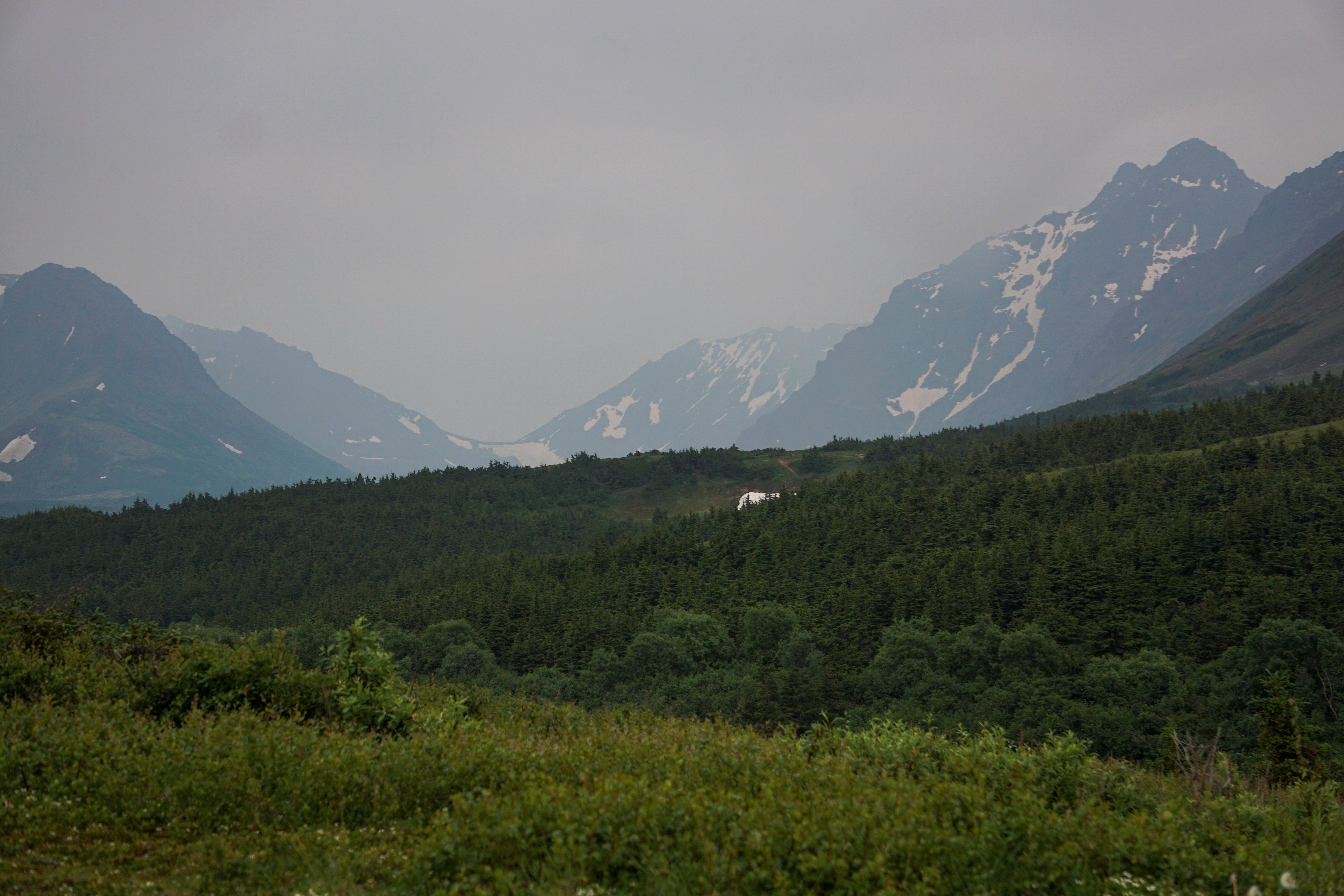 A general view of the mountain valley obscured by smoke taken from the Glen Alps trailhead of Chugach State Park in Anchorage
