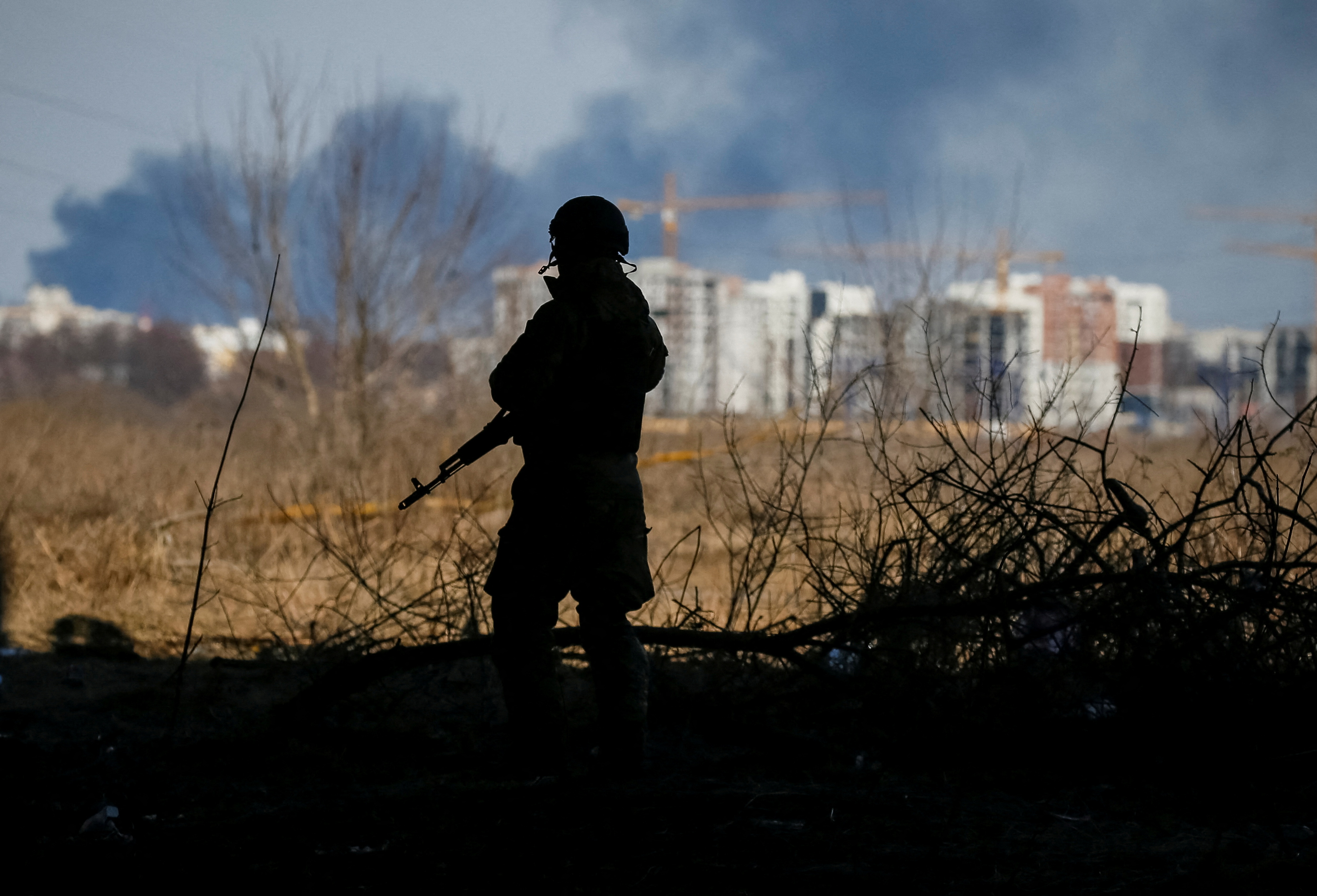 A member of the Ukrainian forces takes a position in Irpin