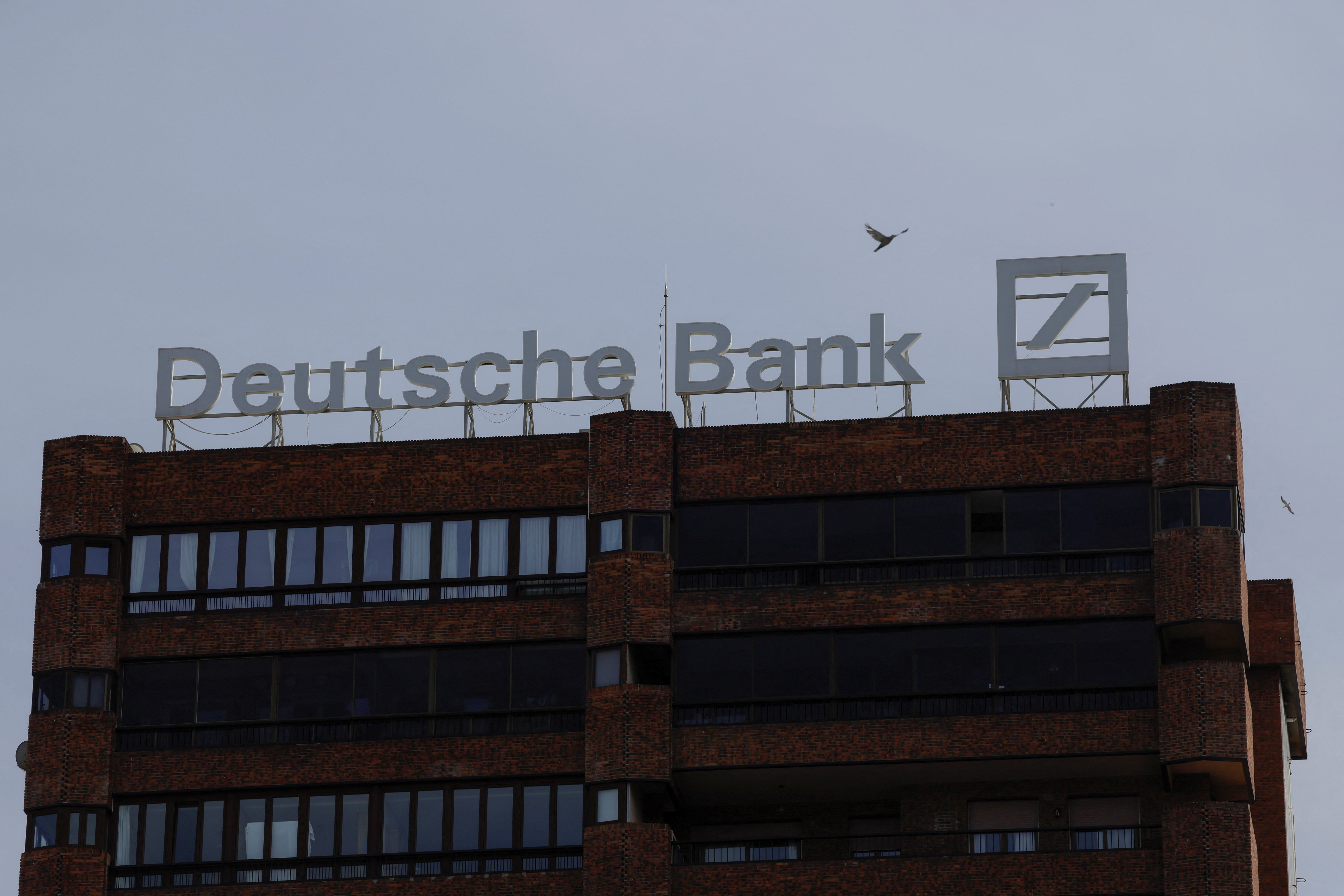 The logo of Deutsche Bank is seen on the roof of a building outside a Deutsche Bank branch office in Malaga