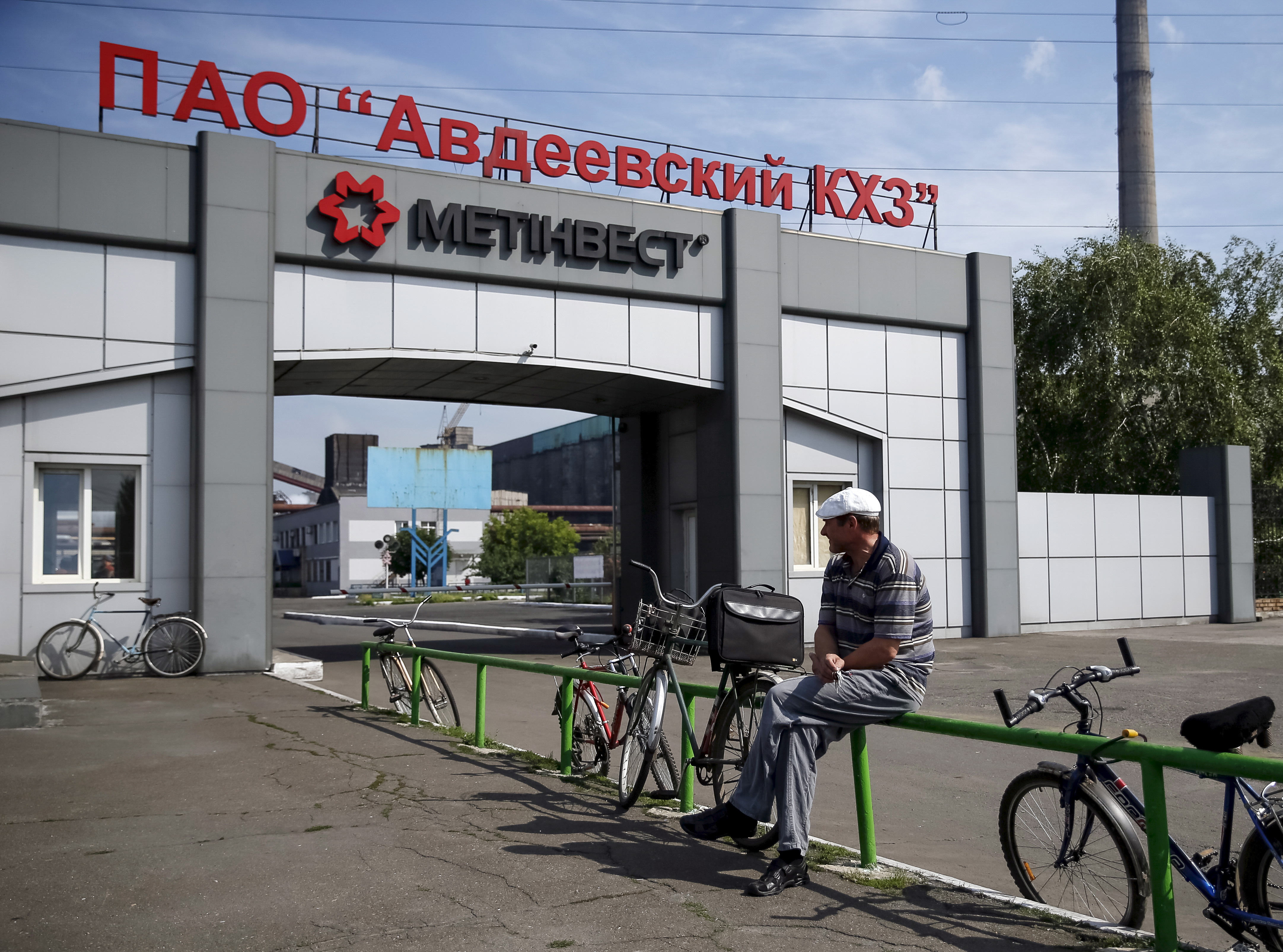 Worker waits near a coke plant in the town of Avdiyivka near Donetsk, eastern Ukraine