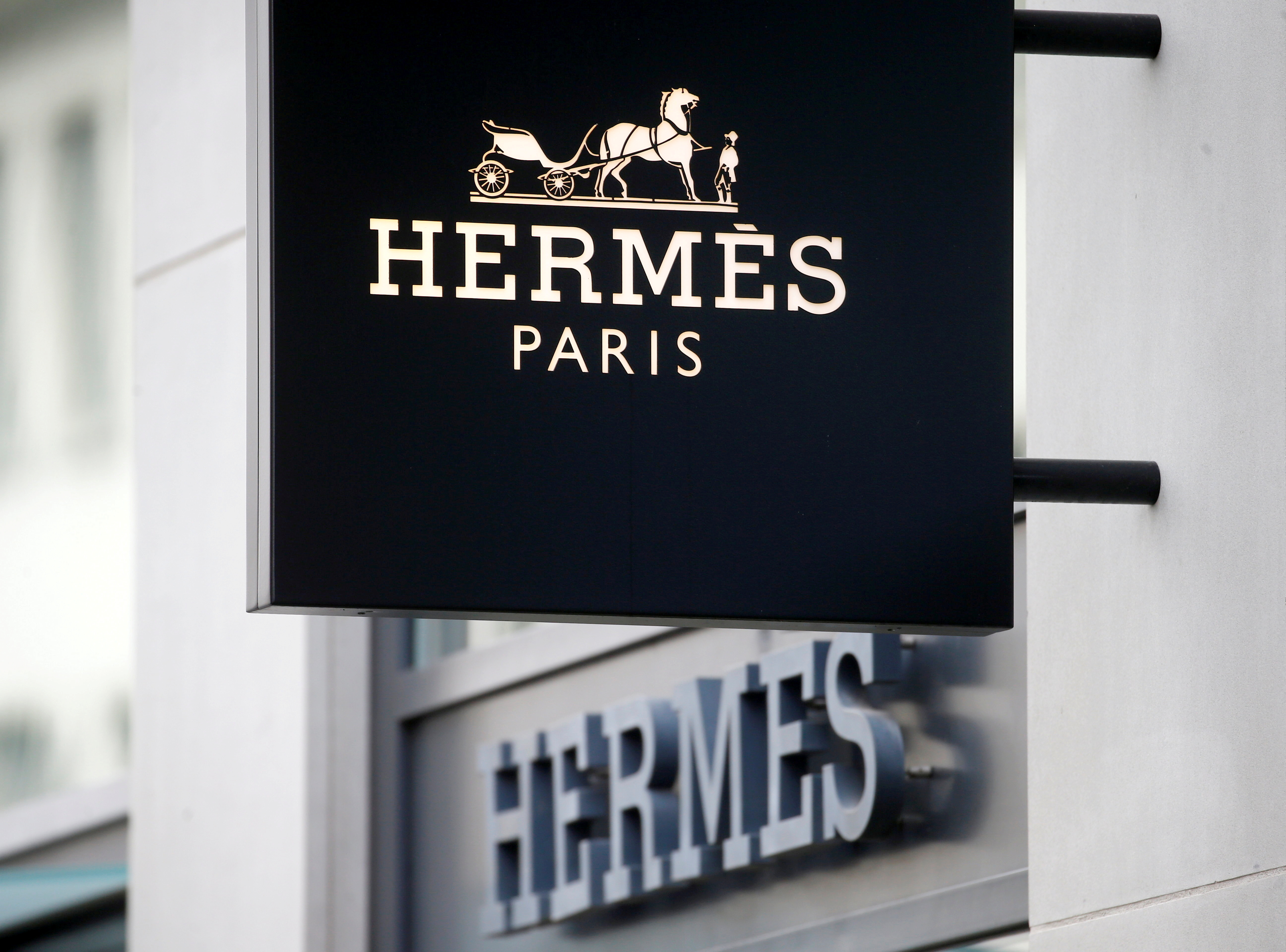 The logo of French luxury group Hermes is seen at a store, as the spread of the coronavirus disease (COVID-19) continues, in Zurich, Switzerland February 17, 2021. REUTERS/Arnd Wiegmann/File Photo 
