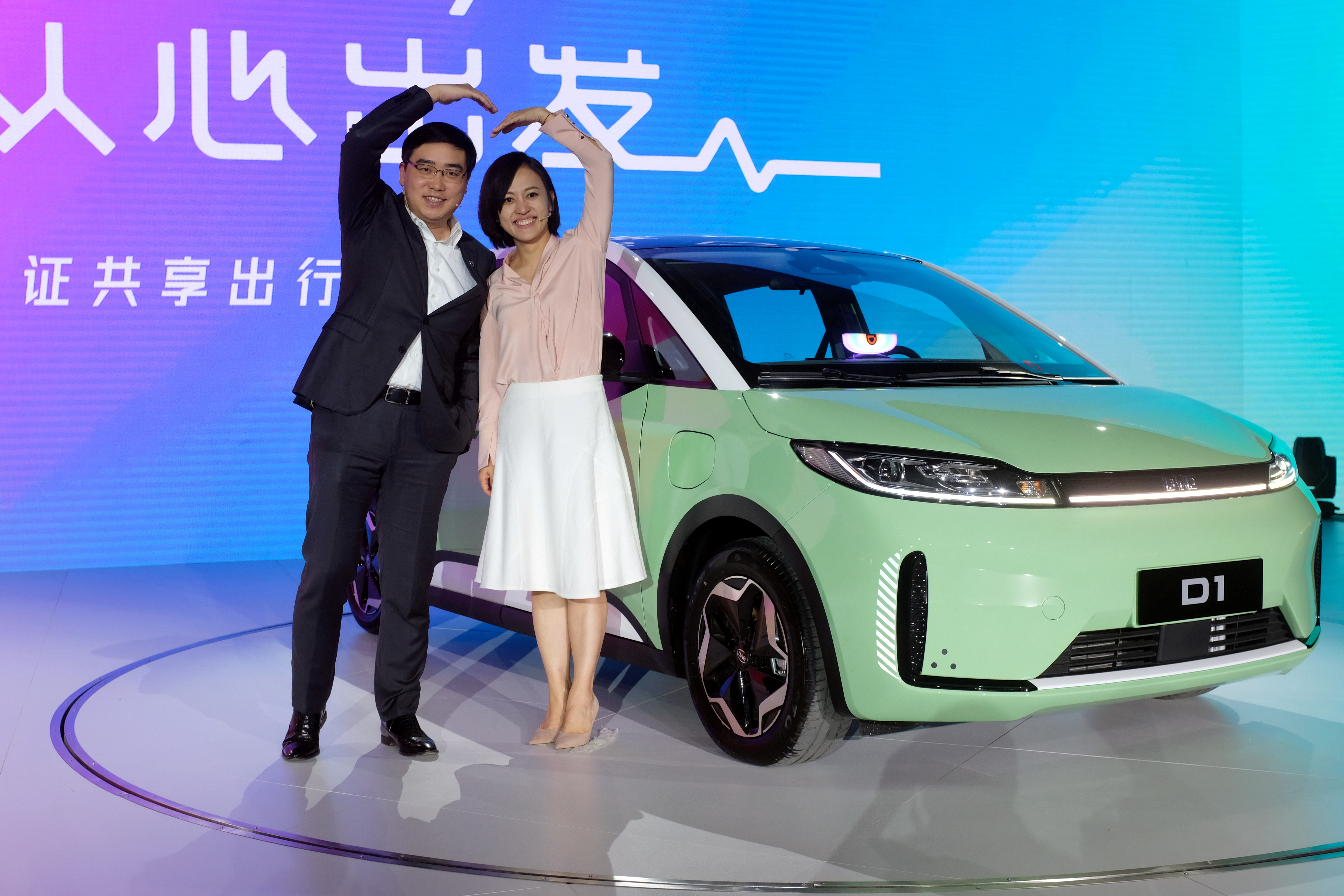 Didi Chuxing's CEO Will Cheng and President Jean Liu attend a launch event in Beijing