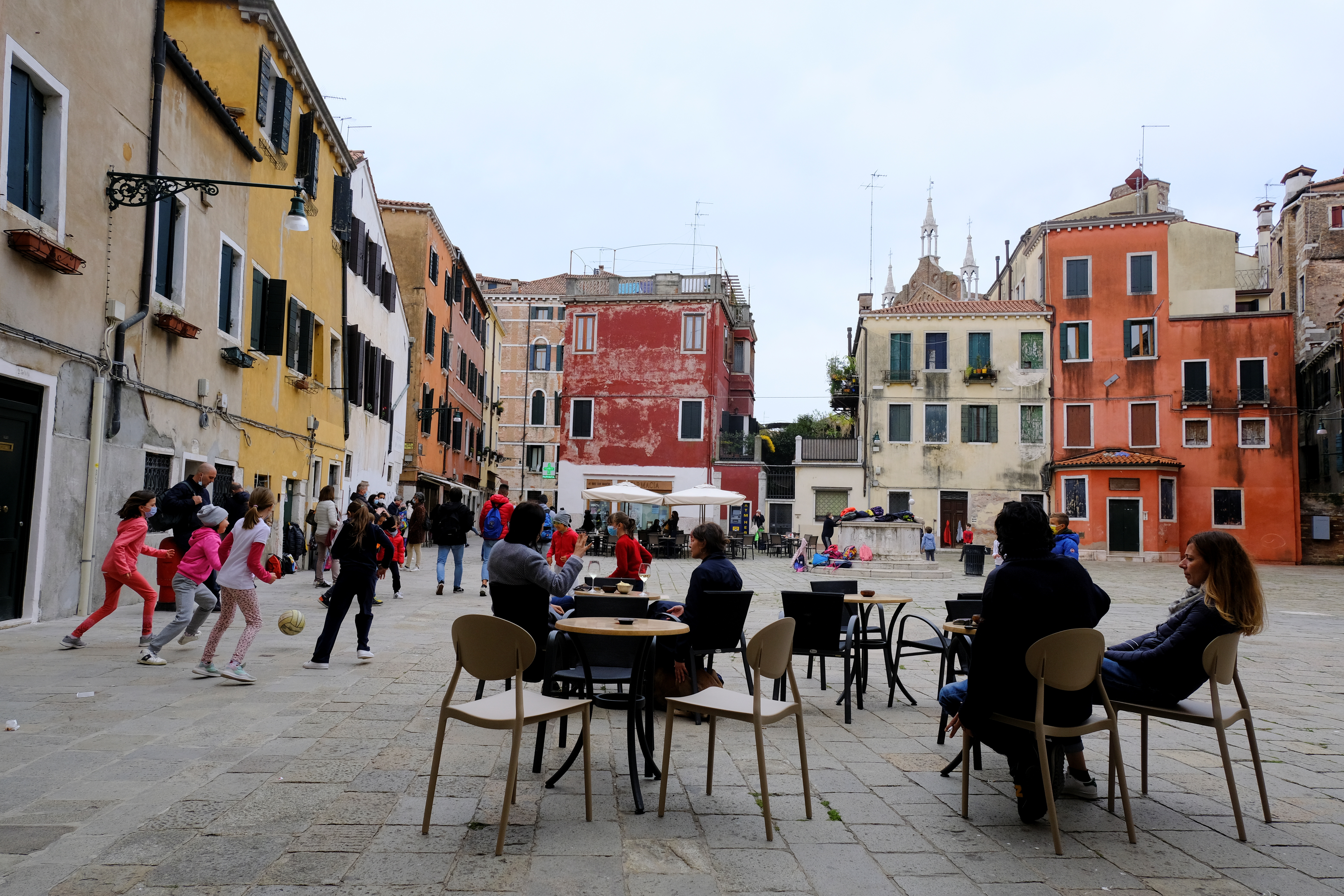 Italians sit at a bar as much of the country becomes a 'yellow zone', easing COVID-19 restrictions, in Venice